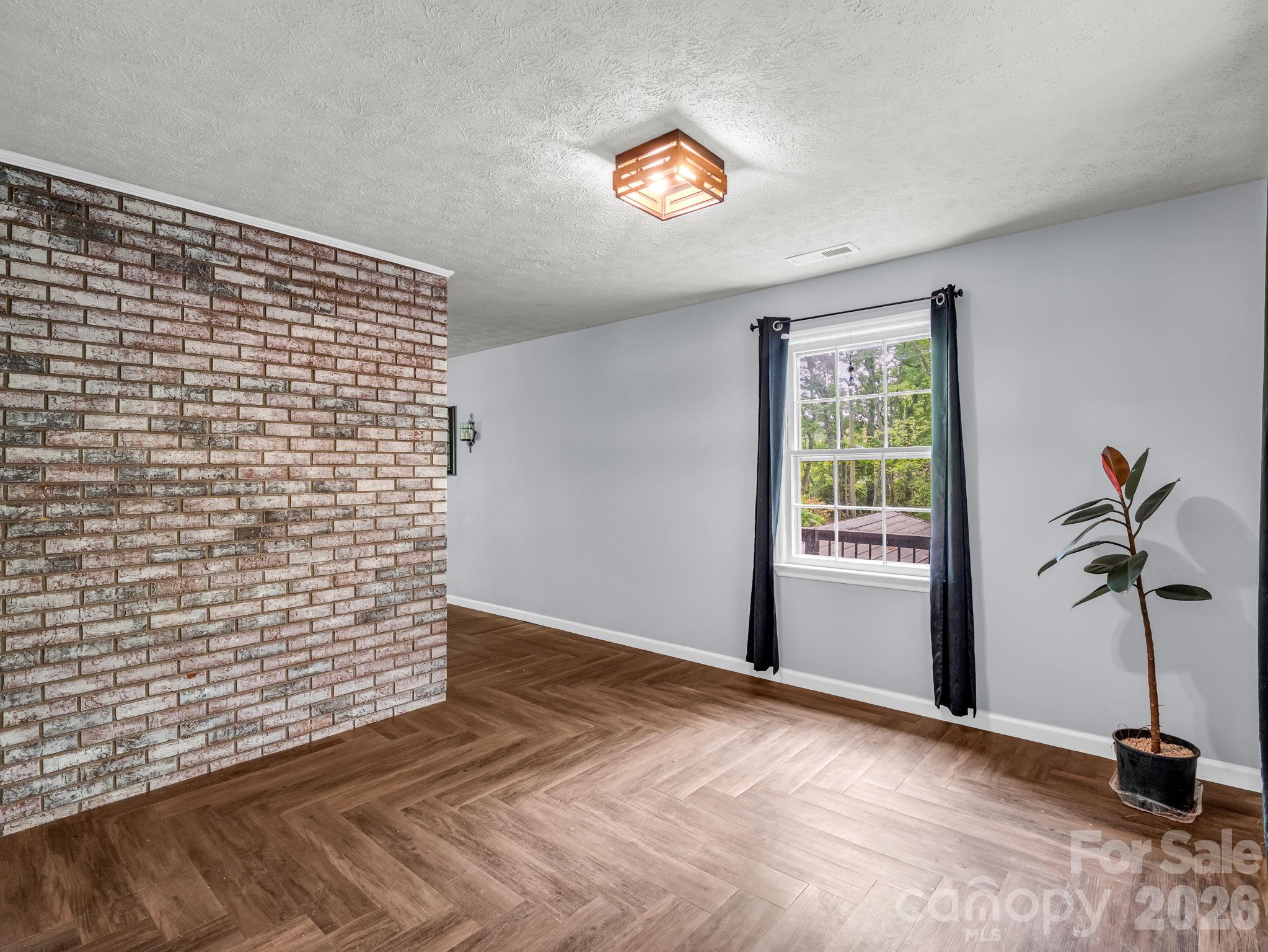 dining room with beautiful exposed brick - 92 Greenwood Acres Drive, Mills River