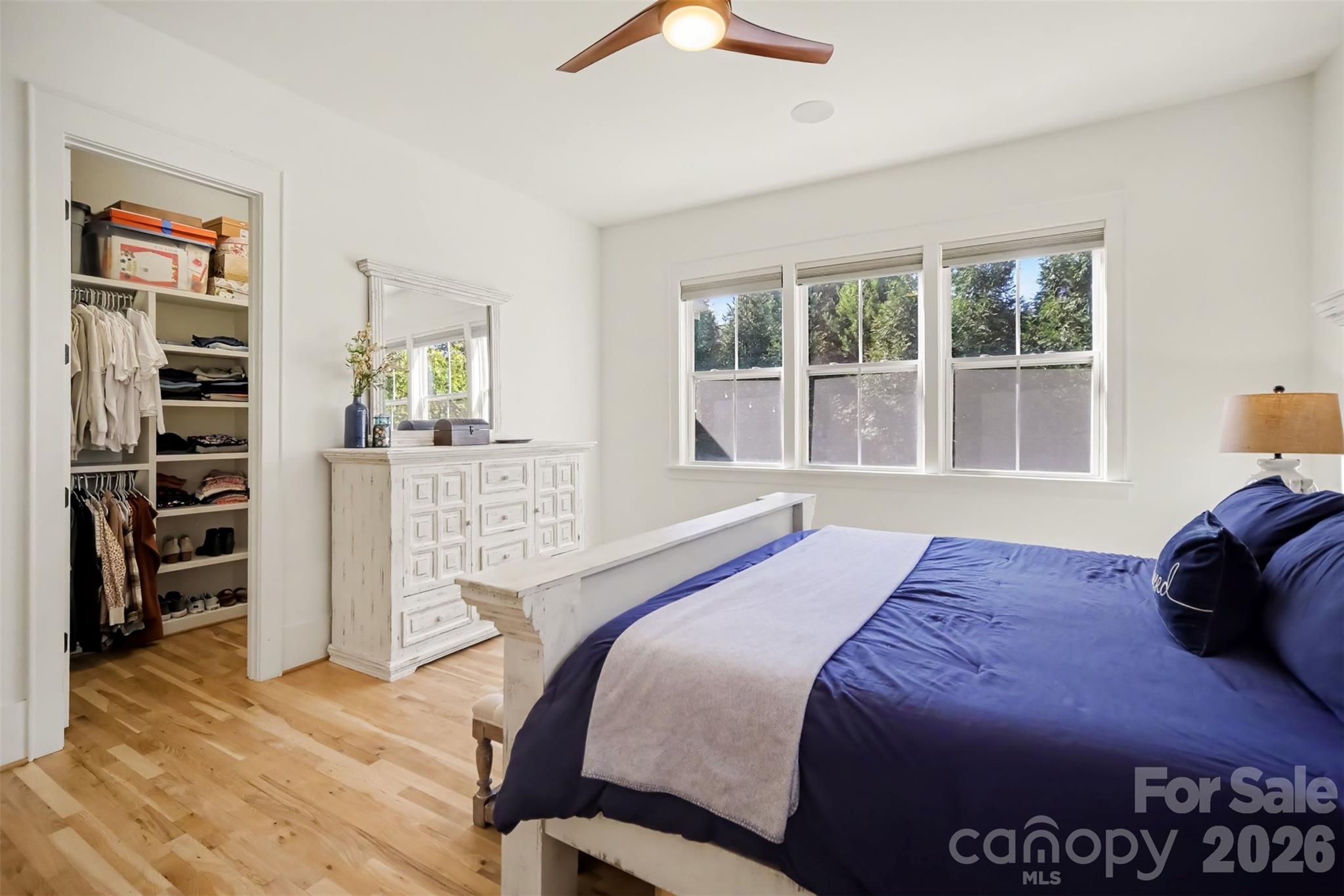 Spacious Primary Suite on Main level with lots of windows and hardwood floors - 206 June Bug Lane, Fort Mill