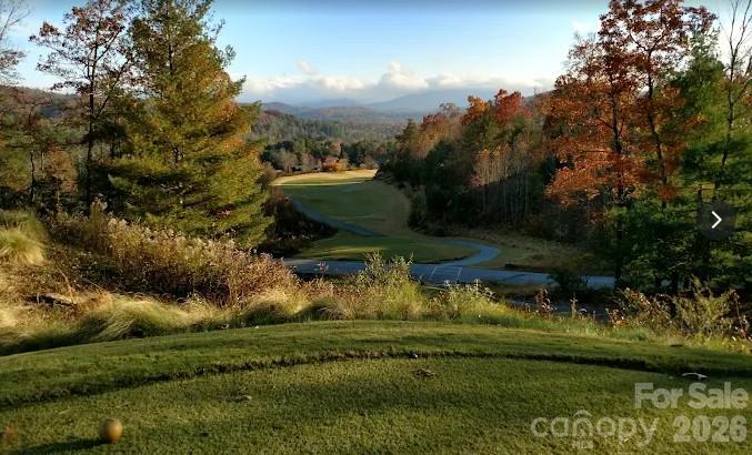 Nearby Cummings Cove offers a scenic mountain golf setting, with rolling fairways framed by mature trees and distant Blue Ridge Mountain views. - 139 Lone Eagle Lane, Hendersonville