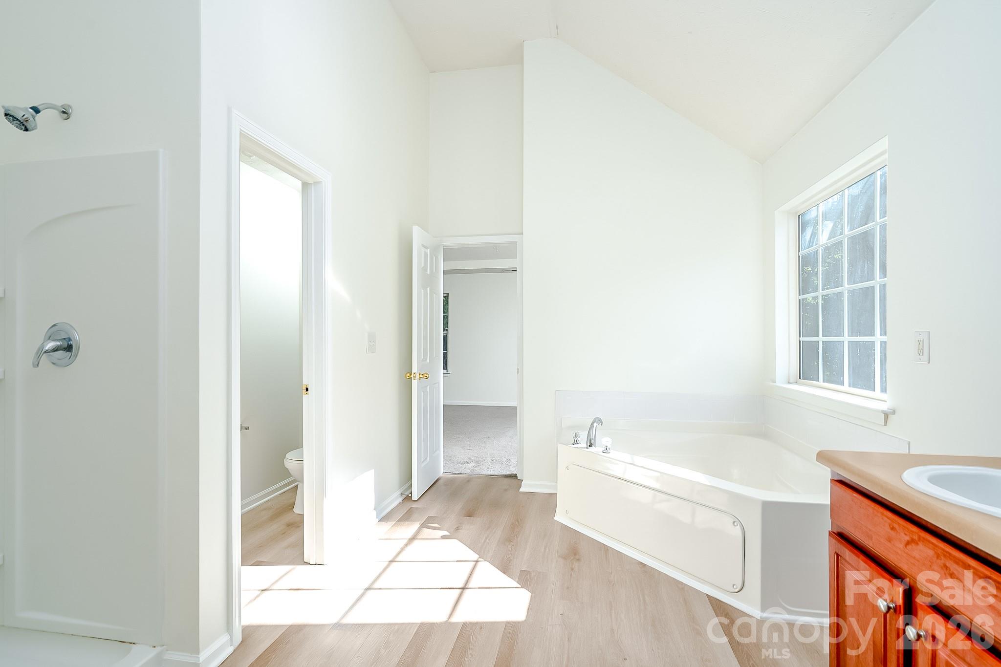 Primary bathroom with garden tub and separate shower - 5124 Eagle Creek Drive, Charlotte