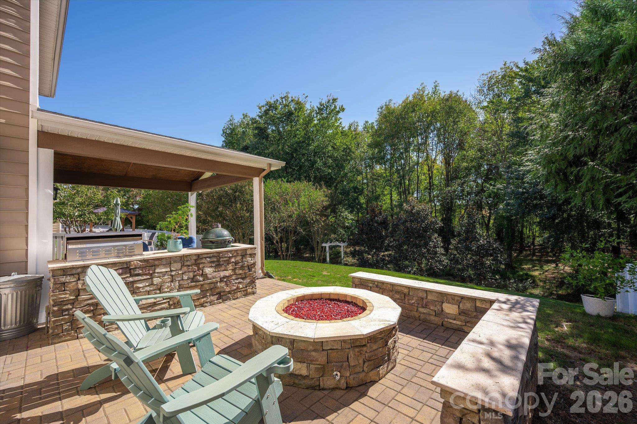 Gas fire pit with stone wall and hand lad pavers - 6107 Cactus Valley Road, Charlotte