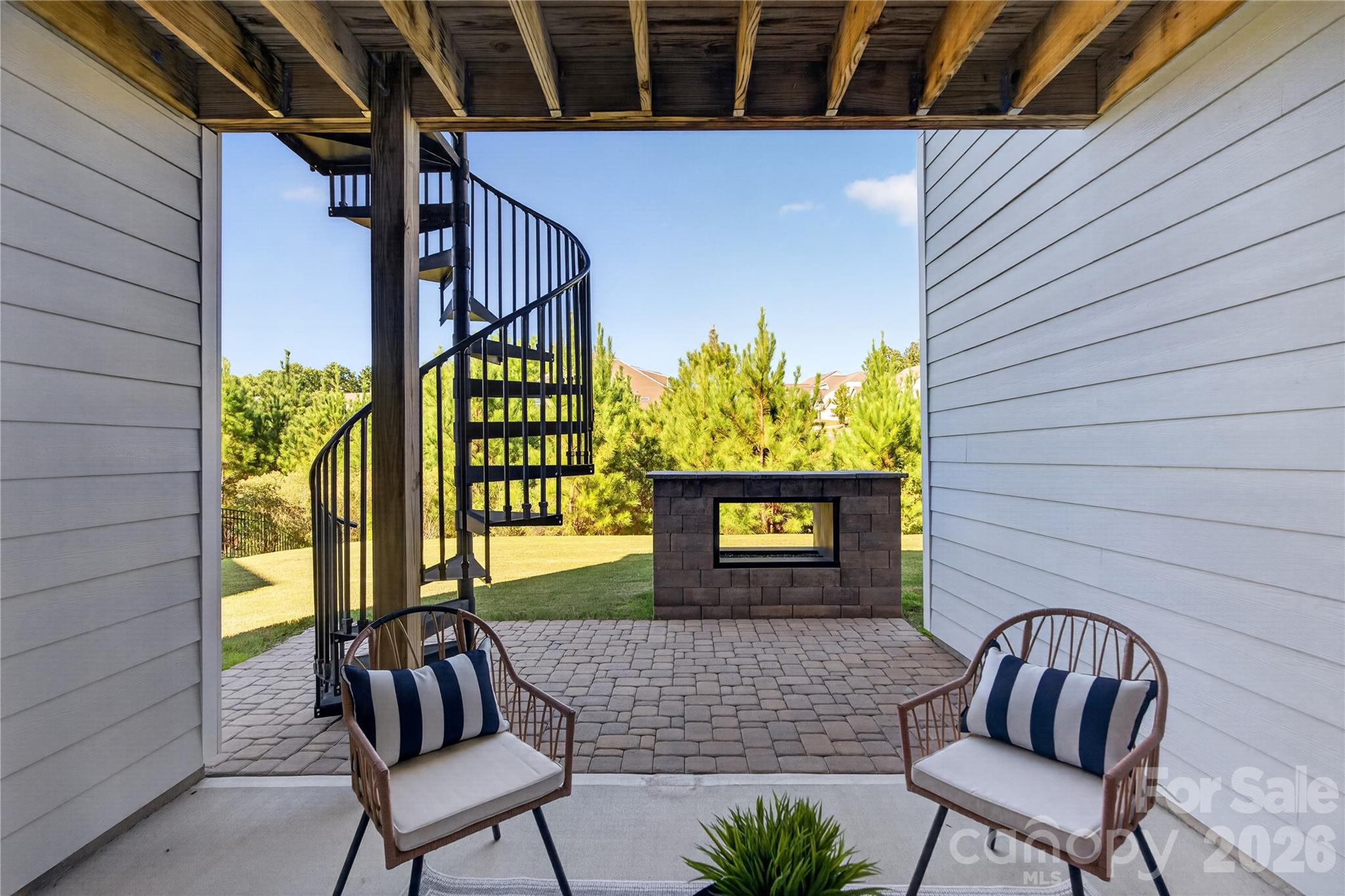 Covered back porch with an outdoor fireplace! - 16815 Lookout Landing Lane, Charlotte