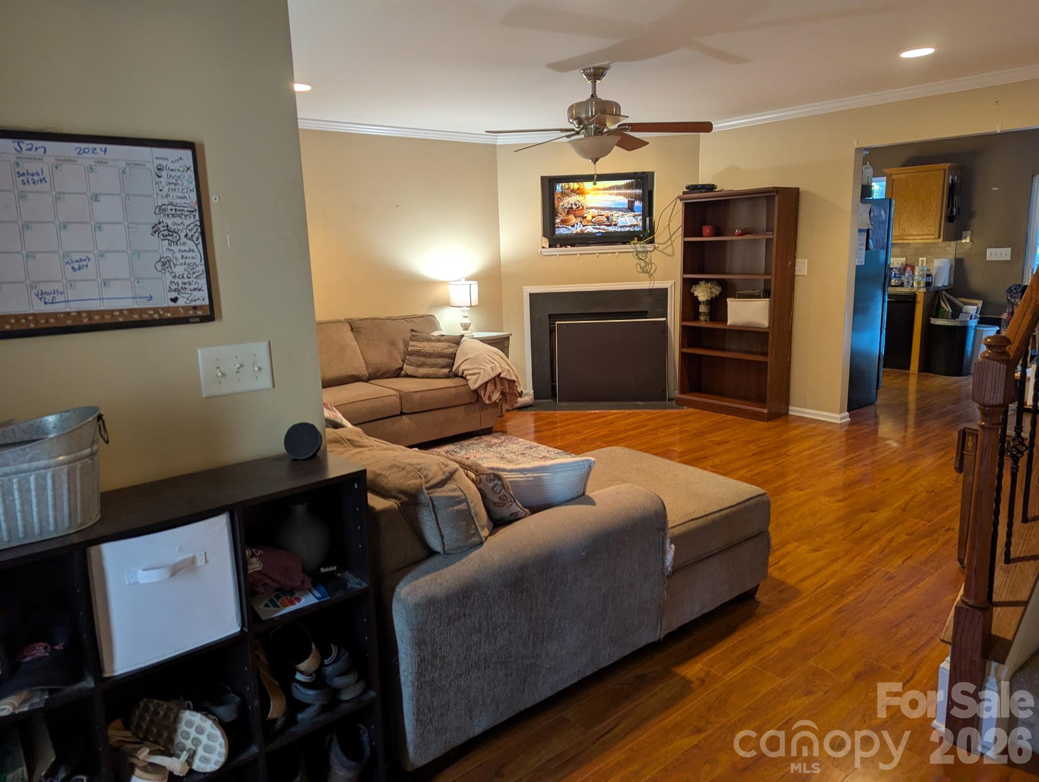 Living room with TV wall and gleaming hardwood floors - 2320 Chantilly Court, Kannapolis