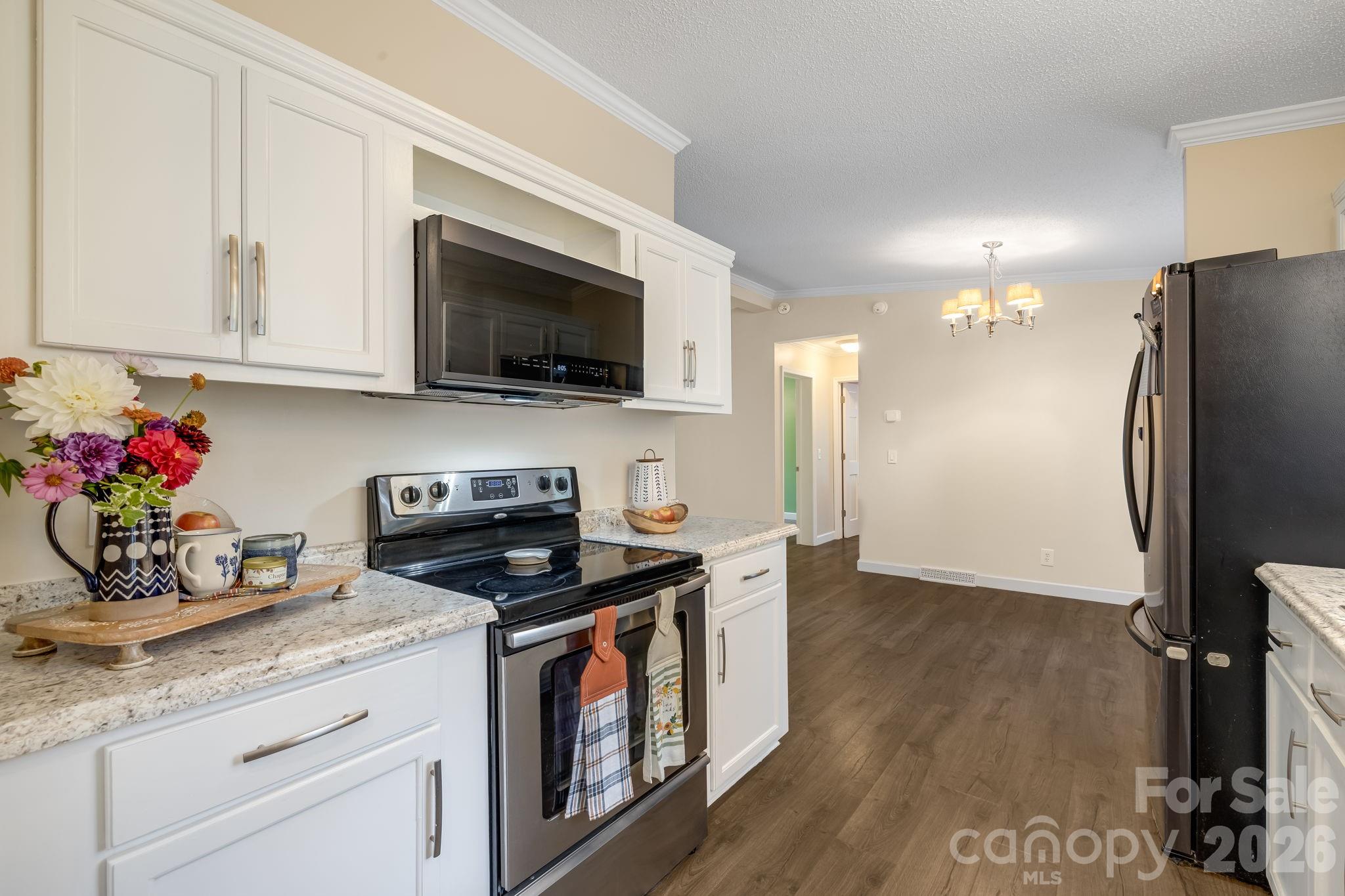 Cook, chat, and stay connected to the living/dining space. - 710 Stoney Mountain Road, Hendersonville