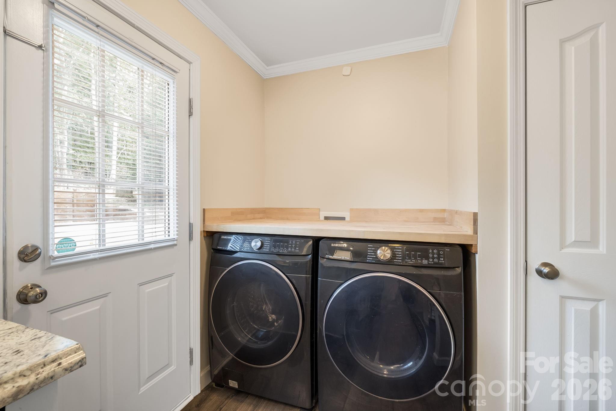 A convenient laundry area right off the kitchen keeps everyday tasks close at hand. - 710 Stoney Mountain Road, Hendersonville