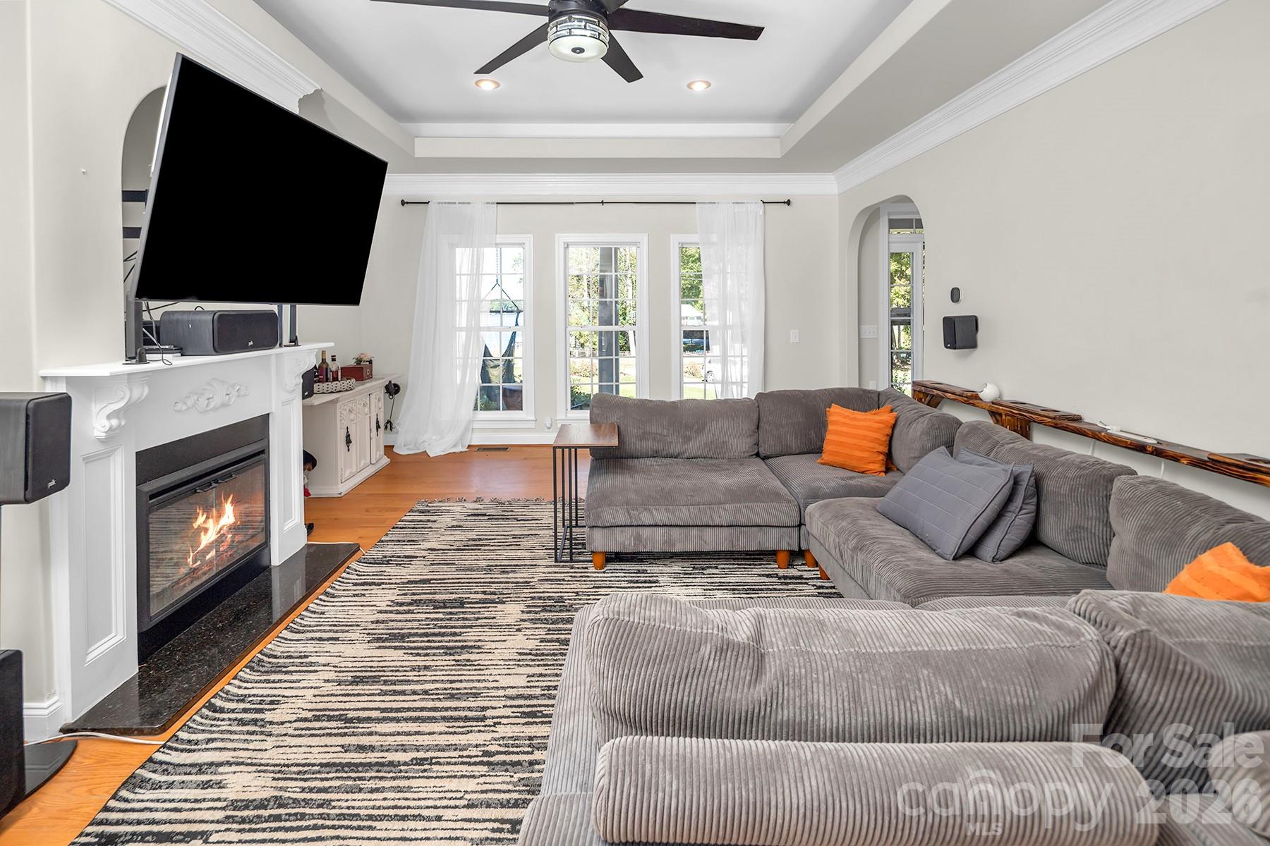 Fireplace virtually staged with a fire. - 5050 Shady Meadow Lane, Denver