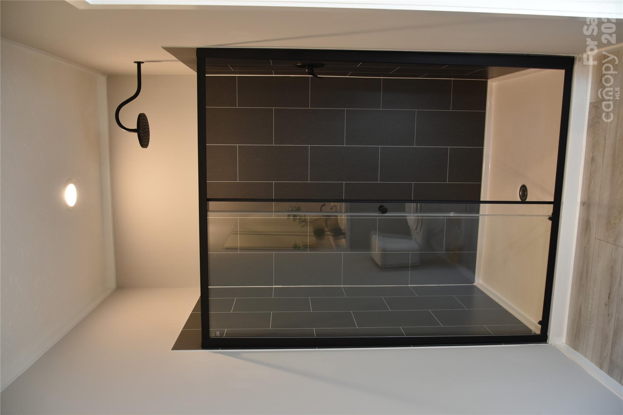 Primary bathroom-tiled shower panels and rain shower head - 105 Cottontail Lane, Statesville