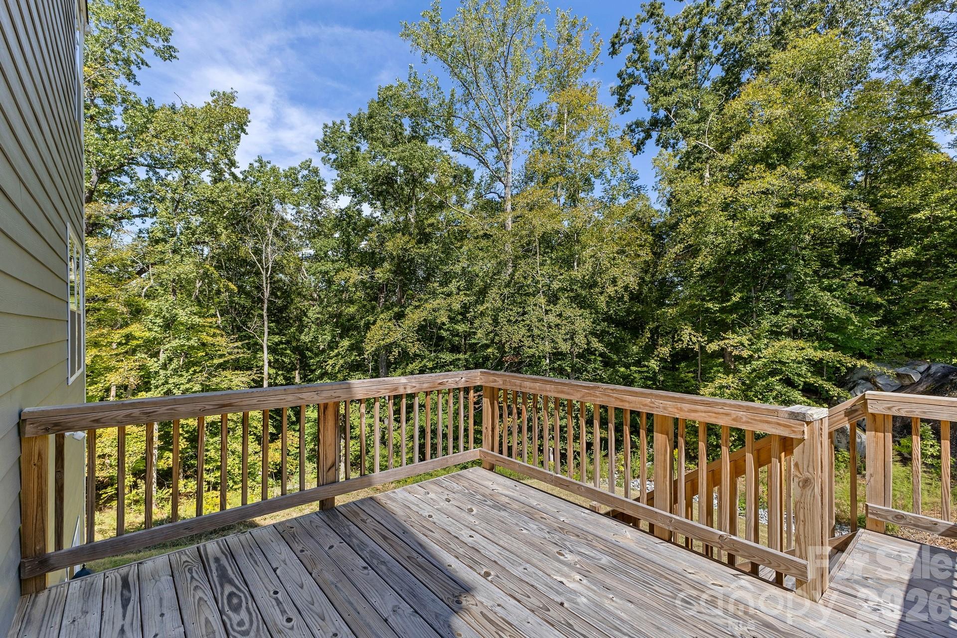 Step outside from the eat-in kitchen onto the rear deck, where the private backyard creates the perfect setting for outdoor dining, entertaining, or simply unwinding at the end of the day. - 3741 Stanley Creek Drive, Mount Holly