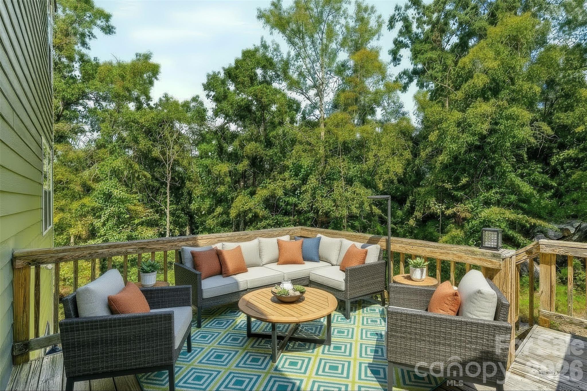 Step outside from the eat-in kitchen onto the rear deck, where the private backyard creates the perfect setting for outdoor dining, entertaining, or simply unwinding at the end of the day. - 3741 Stanley Creek Drive, Mount Holly