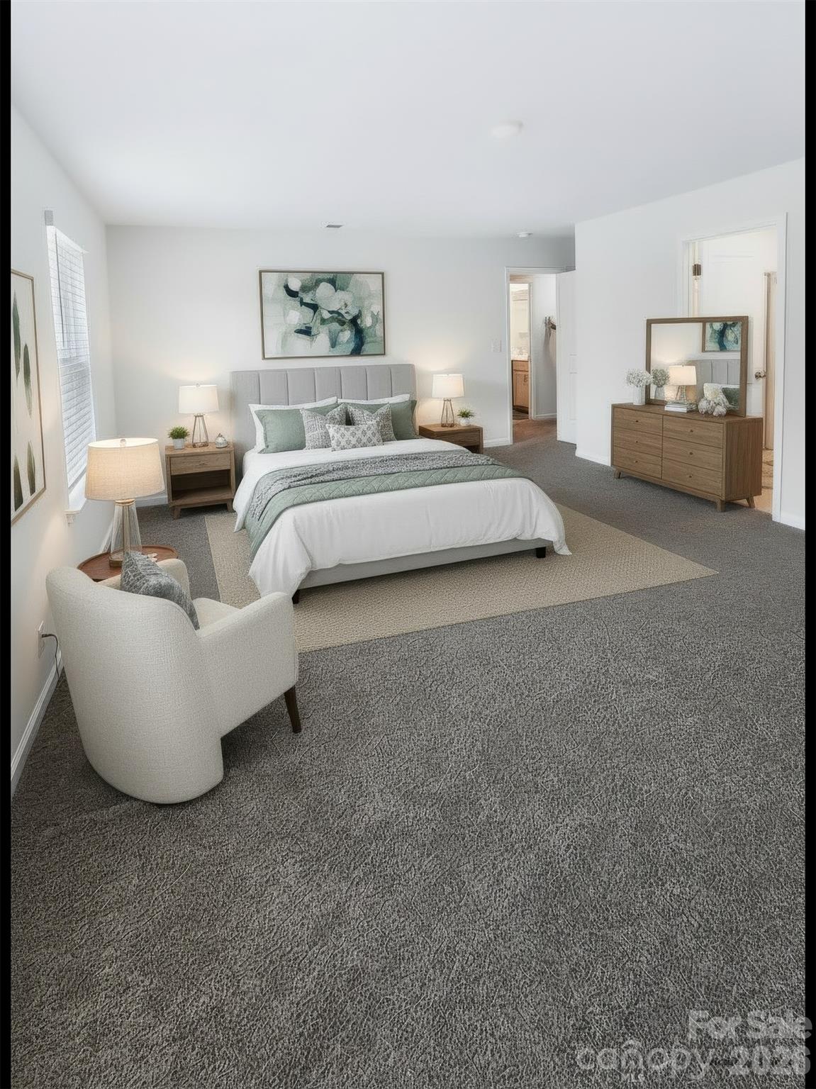 Prepare to be impressed by this massive primary bedroom, offering an expansive layout that effortlessly accommodates oversized furniture and a cozy relaxation space. Two large windows fill the room with light to create a bright, peaceful space complete with a generous walk-in closet. - 3741 Stanley Creek Drive, Mount Holly