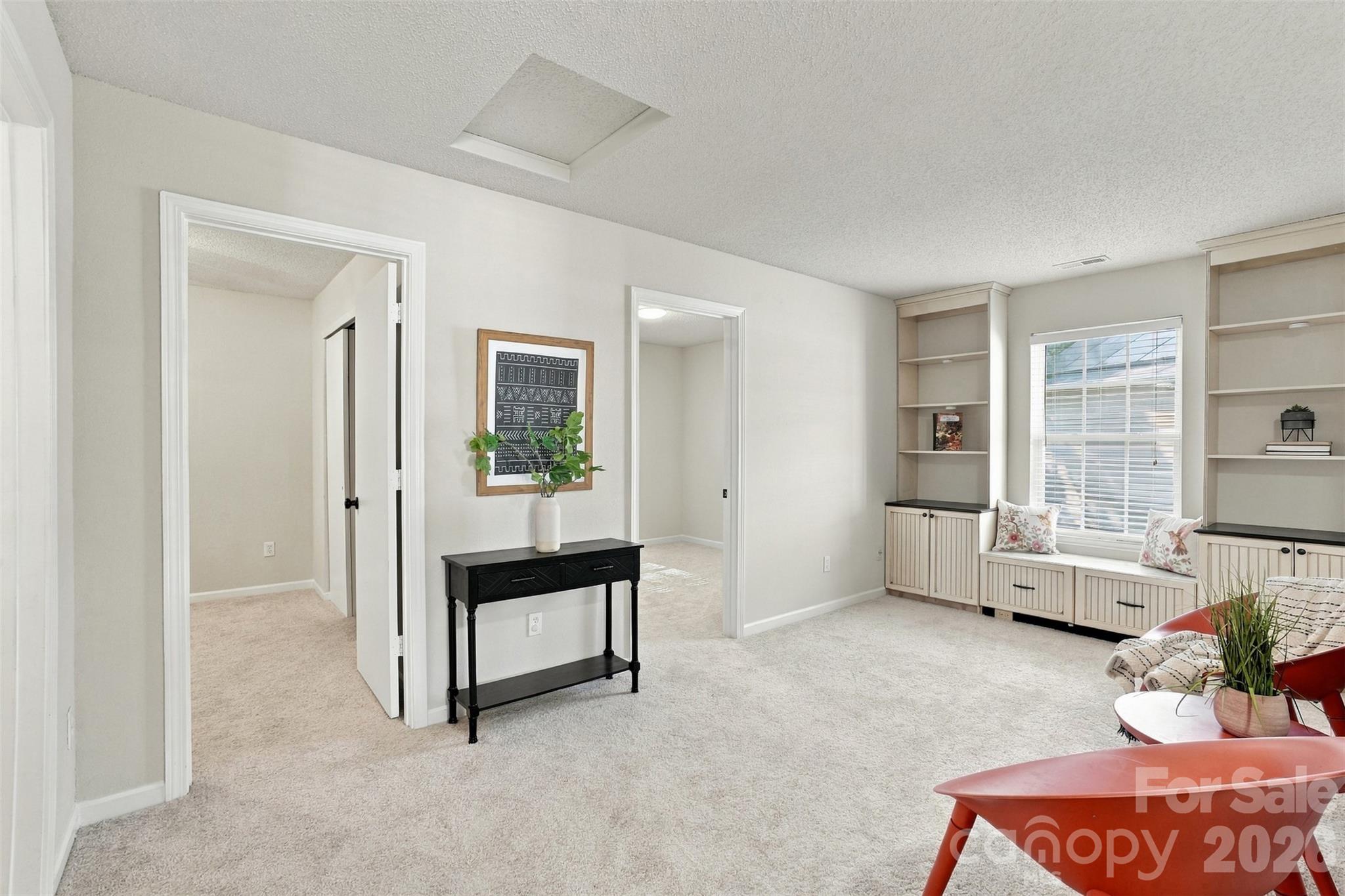 Loft area w/built-in bookshelves, cabinets and window seat. - 1901 Beckwith Lane, Waxhaw
