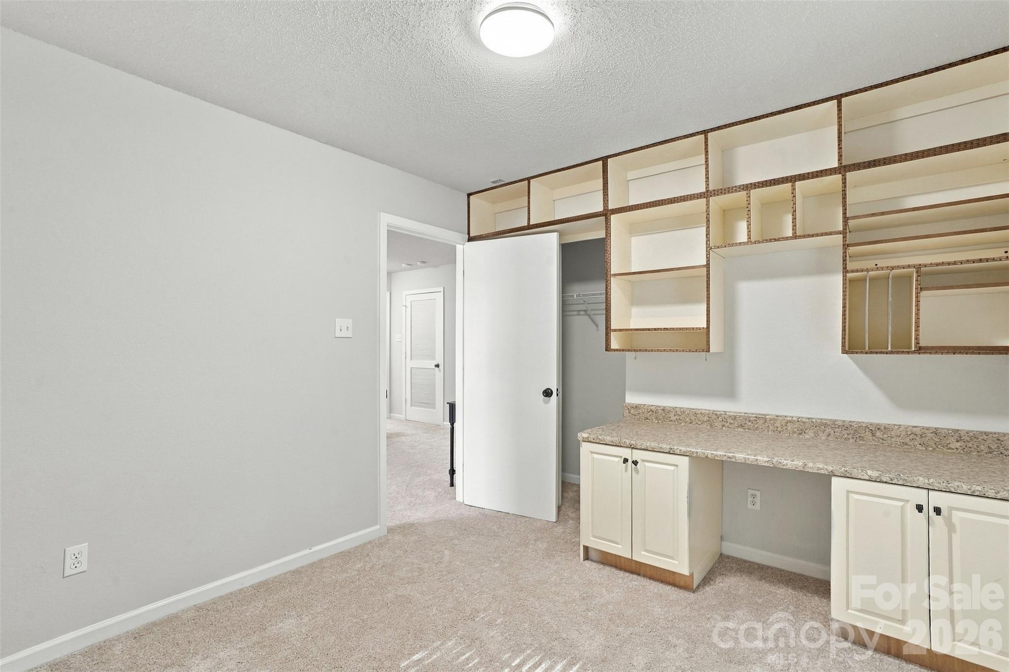Secondary bedroom with built-in desk and organizer. - 1901 Beckwith Lane, Waxhaw