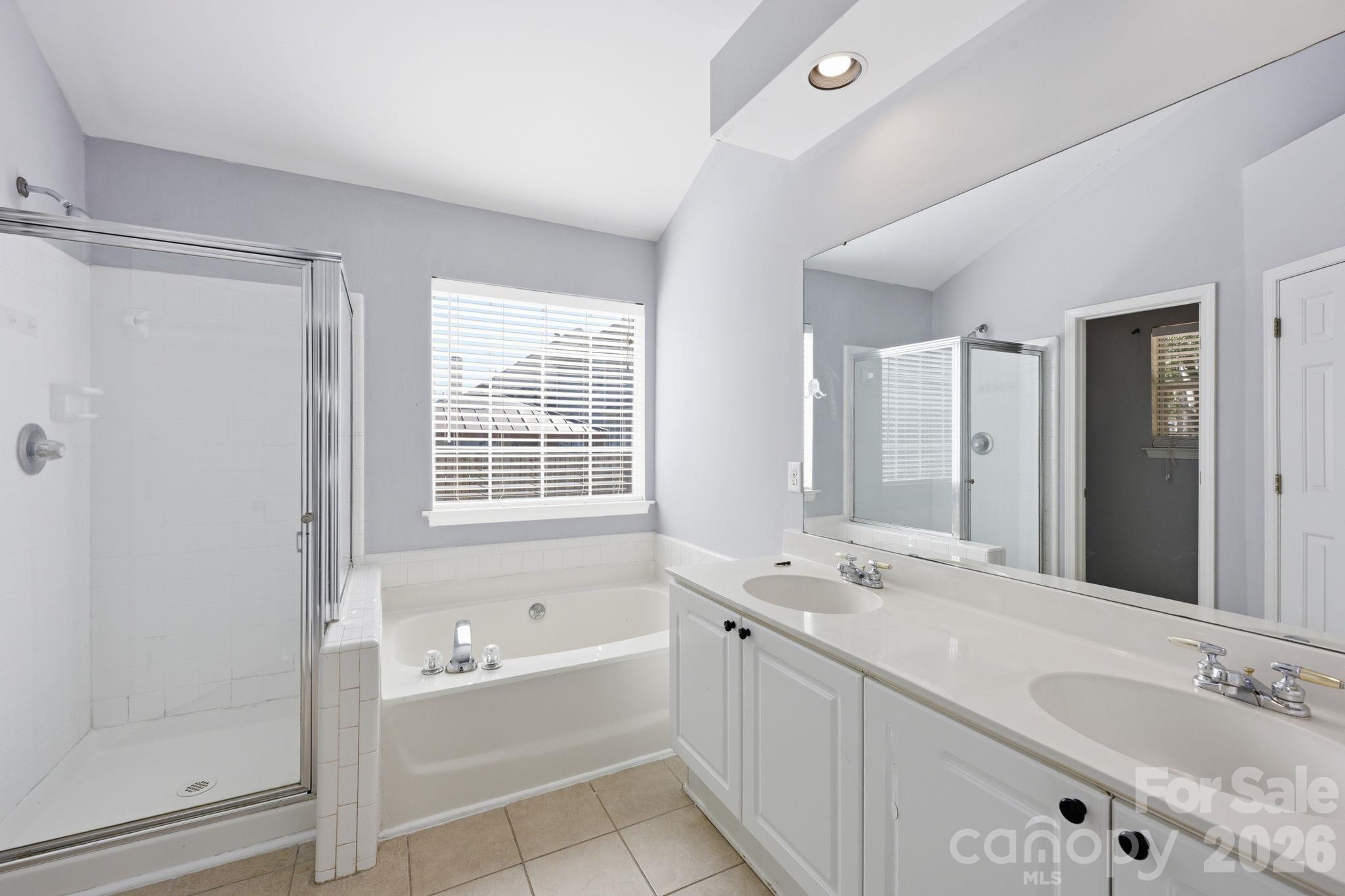 The Primary Bathroom offers dual sinks so getting ready is easy! - 4000 Huntmeadow Drive, Charlotte