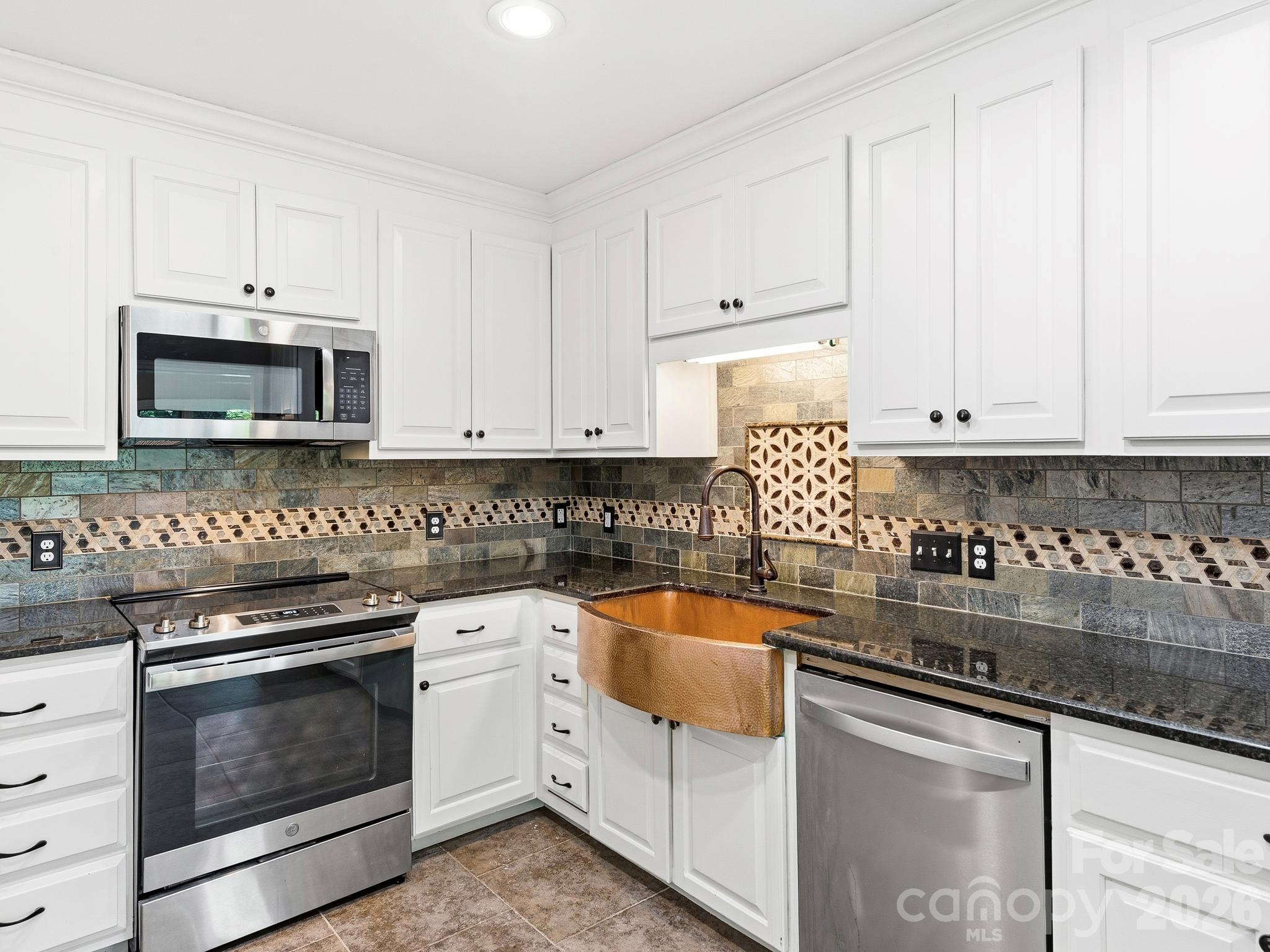 The kitchen features a copper farmhouse sink and stainless appliances including a new refrigerator. - 175 Mimosa Road, Columbus