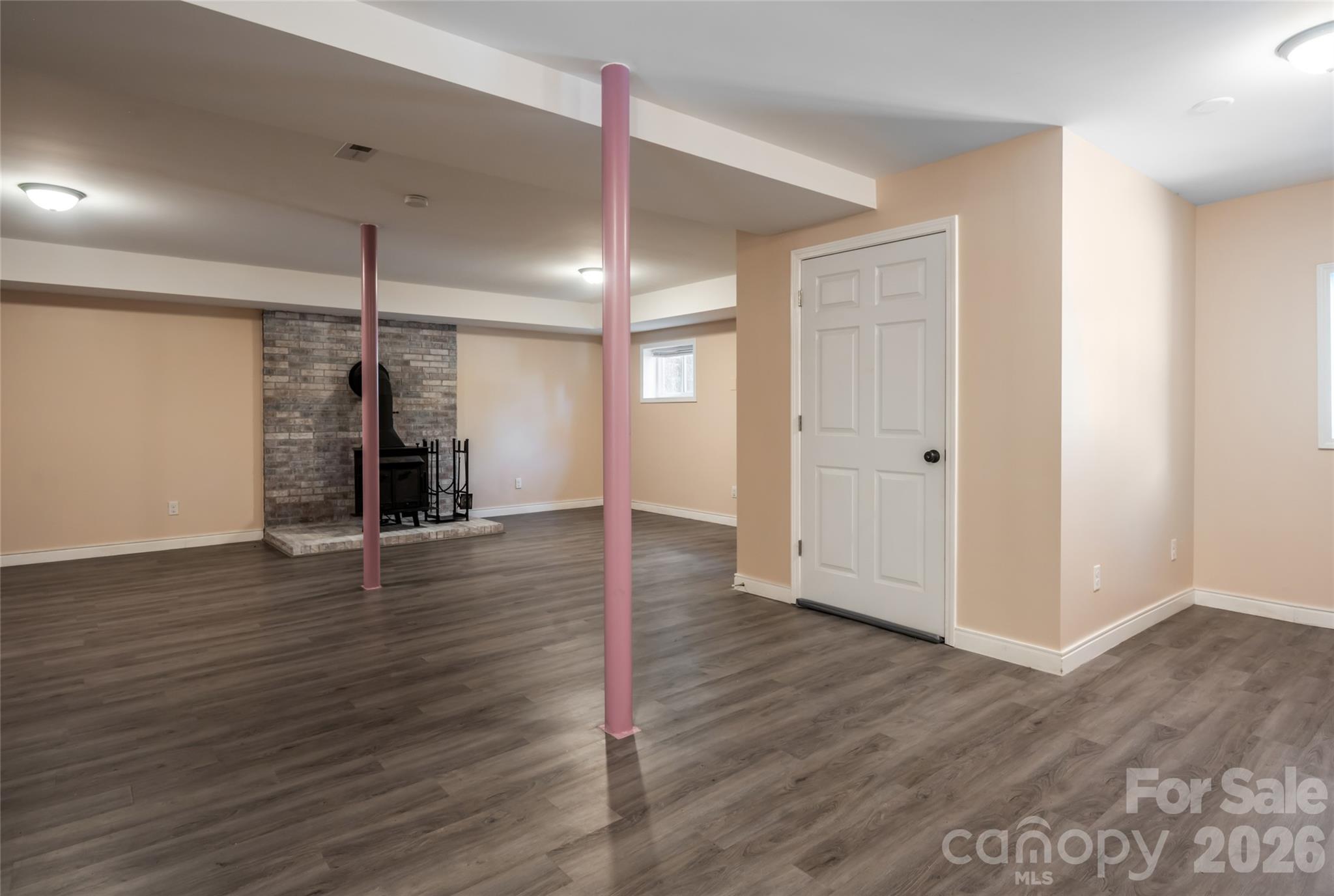 Open lower level with wood burning fireplace. - 207 Beechwood Lakes Drive, Hendersonville