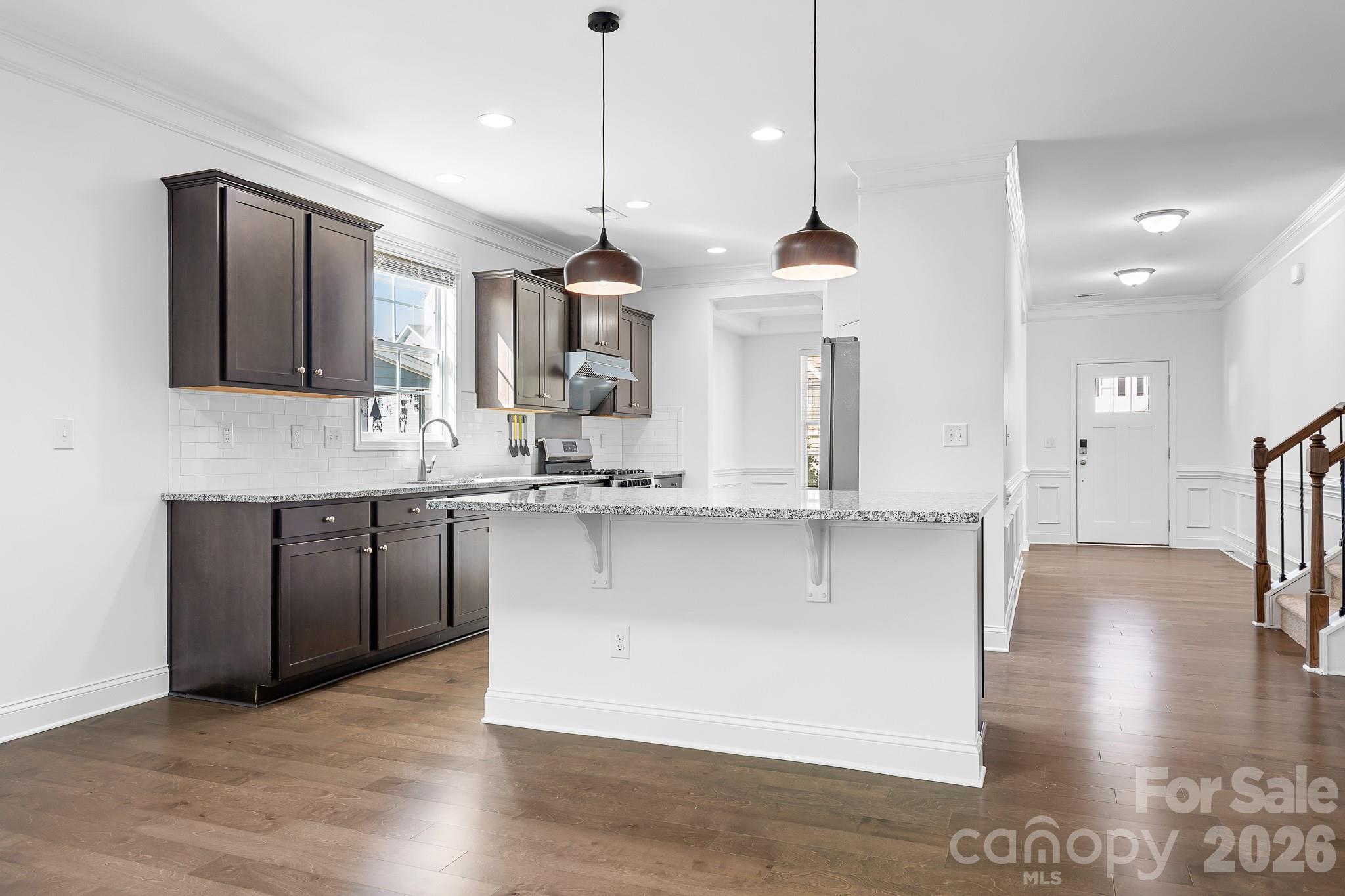 The warm and open kitchen has lots of counter and prep space, new lighting, and granite countertops. - 3967 Lake Breeze Drive, Sherrills Ford