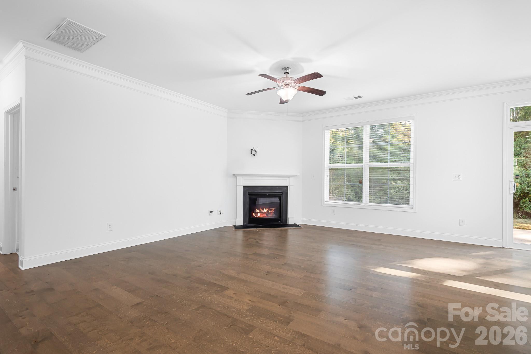 The living room is spacious and light filled. Tucked just beyond is a drop zone, full bathroom and guest bedroom. - 3967 Lake Breeze Drive, Sherrills Ford