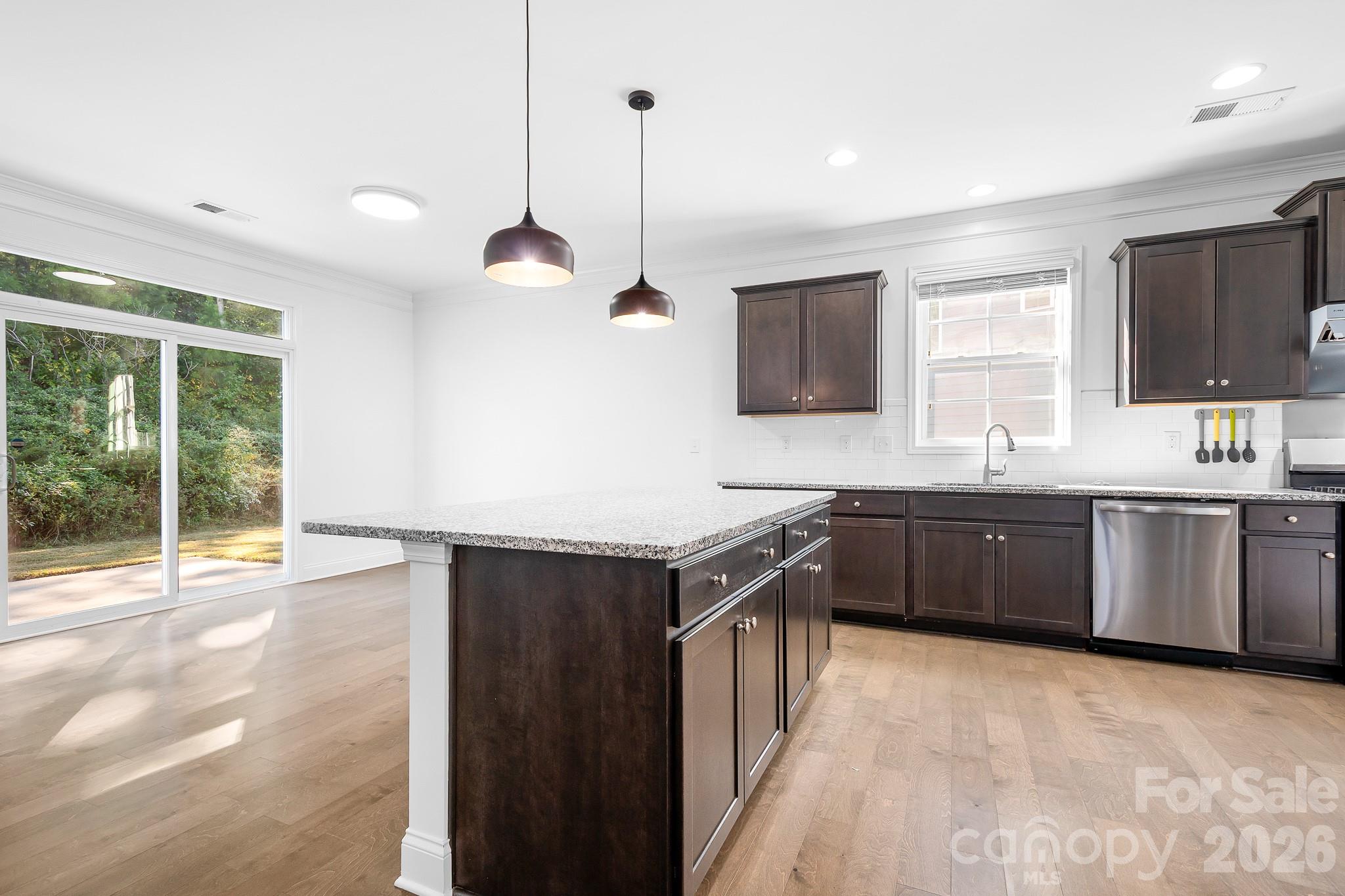 Sliders lead to the lovely outdoor space where a big patio is great for outdoor dining and the paver fire pit is great for our wonderful Carolina evenings. - 3967 Lake Breeze Drive, Sherrills Ford