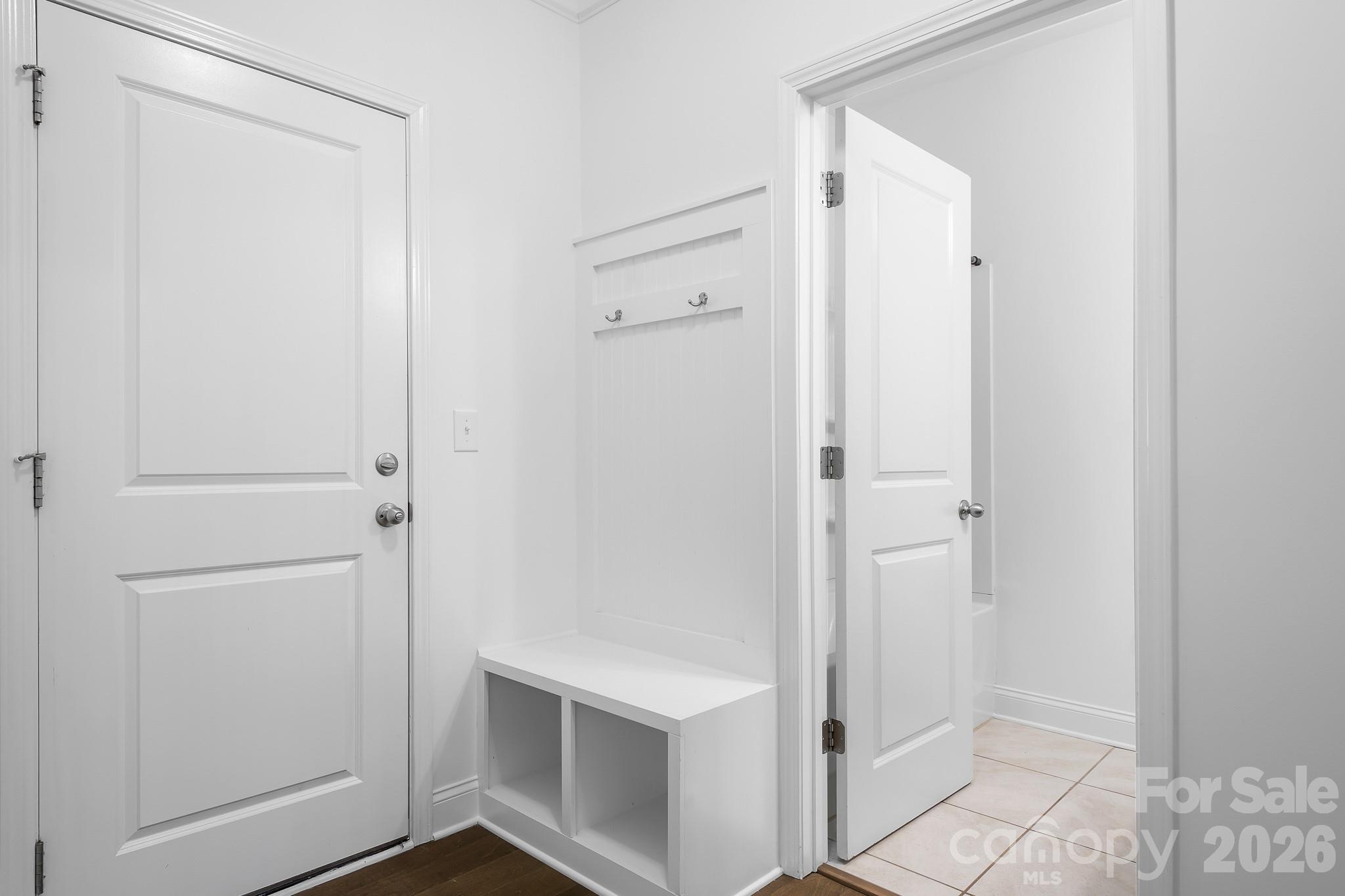 the garage leads to a tucked drop zone and beyond to the full bath and guest bedroom. A storage closet completes this space. - 3967 Lake Breeze Drive, Sherrills Ford