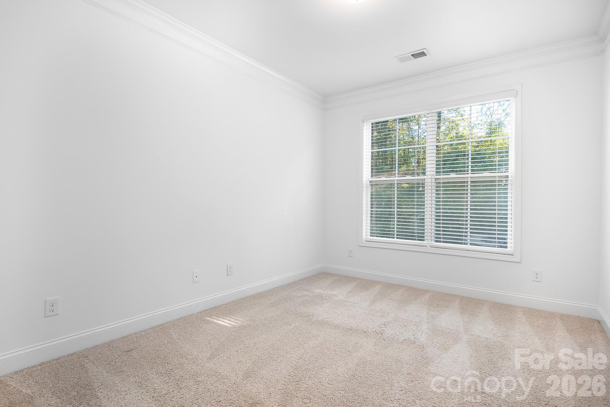 The main level guest bedroom overlooks the peaceful backyard. - 3967 Lake Breeze Drive, Sherrills Ford