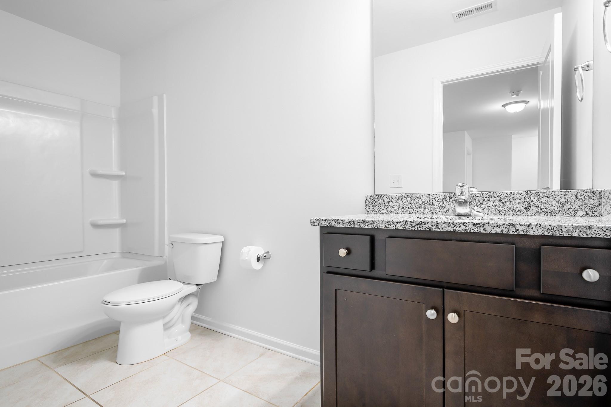 The full bath on the main offers lots of cabinet space and even space for a shelf. - 3967 Lake Breeze Drive, Sherrills Ford