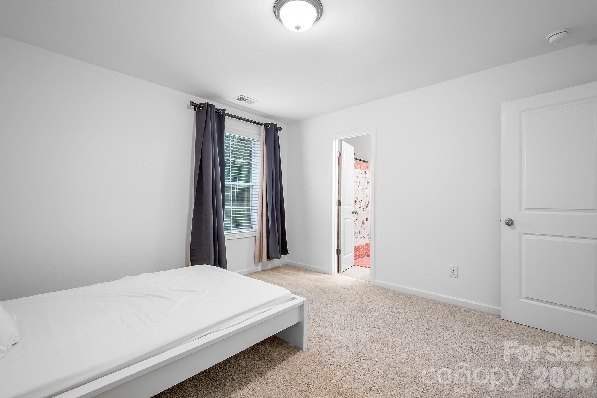 Upper level guest bedroom connects to Jack-and-Jill Bath. - 3967 Lake Breeze Drive, Sherrills Ford