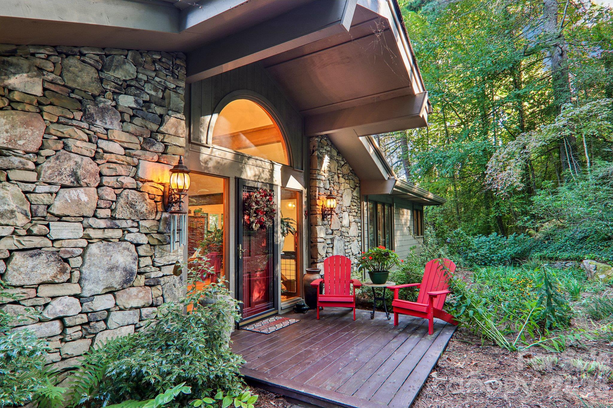 Inviting front door with natural rock accents and covered porch. - 212 Pheasant Run, Hendersonville