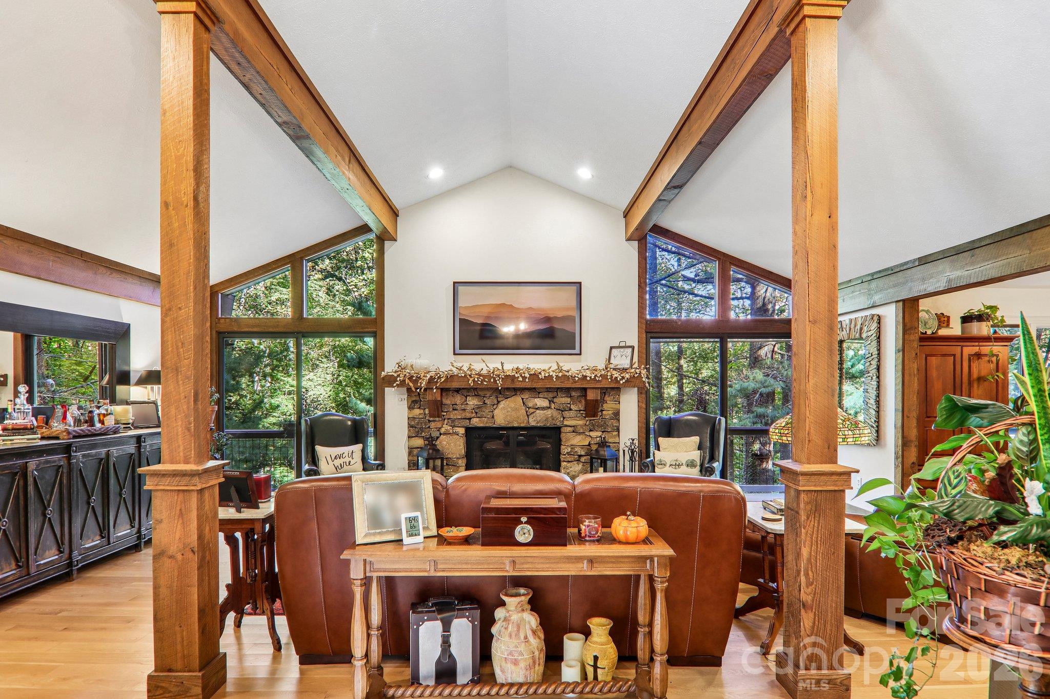 Wall of windows and cozy rock fireplace, reclaimed wooded beams and trim - 212 Pheasant Run, Hendersonville