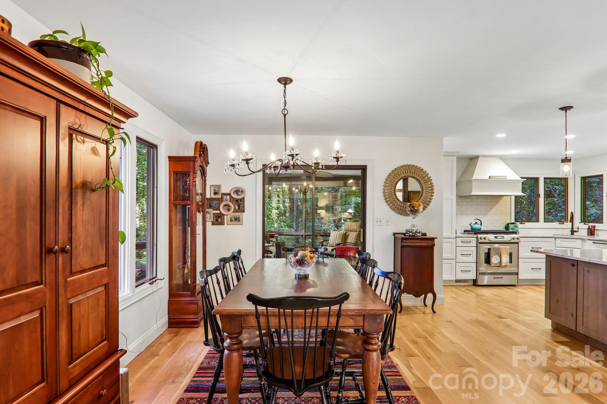 Dining area and entry sliding doors to the screened in porch. - 212 Pheasant Run, Hendersonville