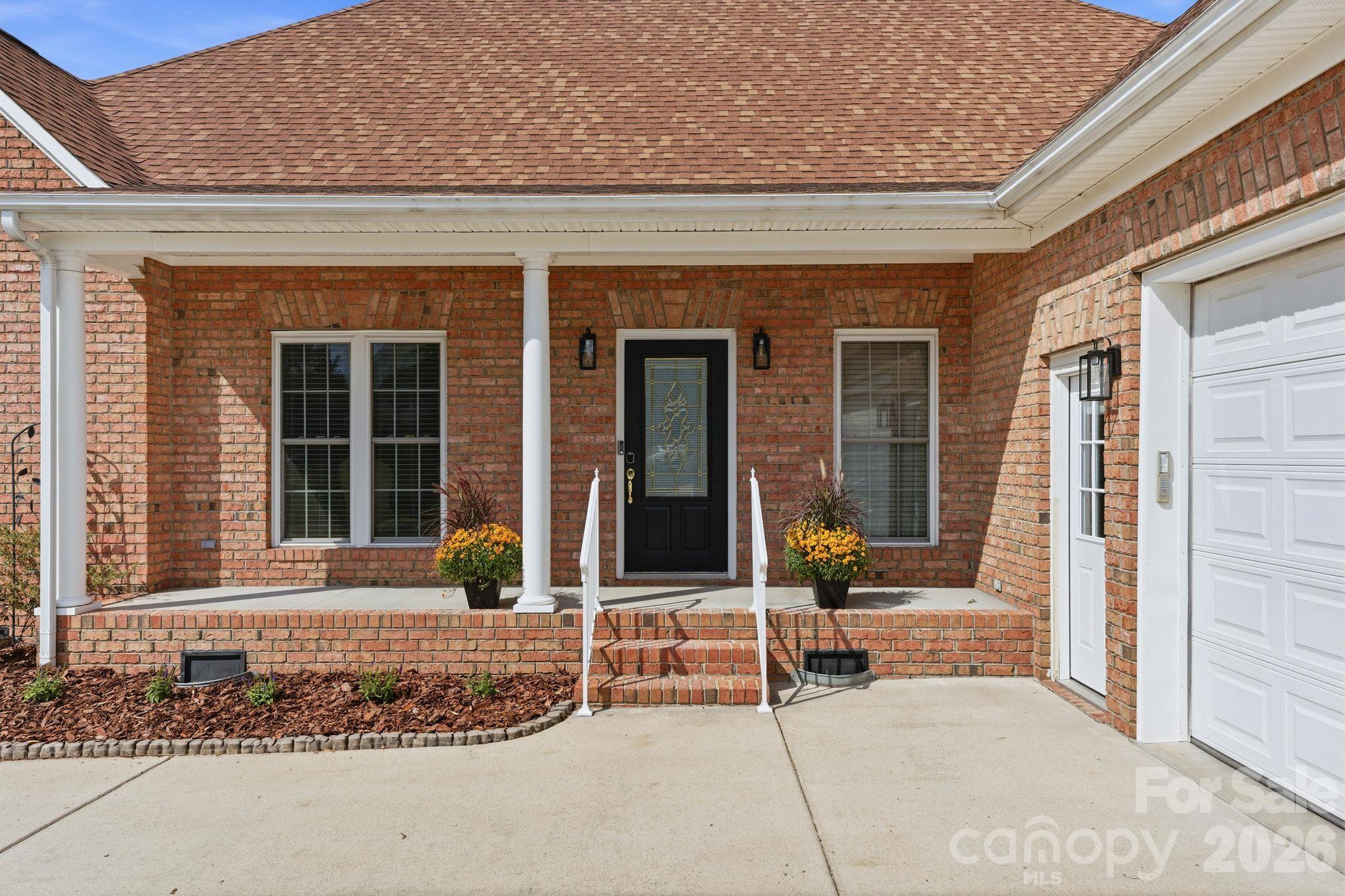 Welcoming covered porch and oversized side-entry garage with passenger door - 803 Amanda Way, Albemarle