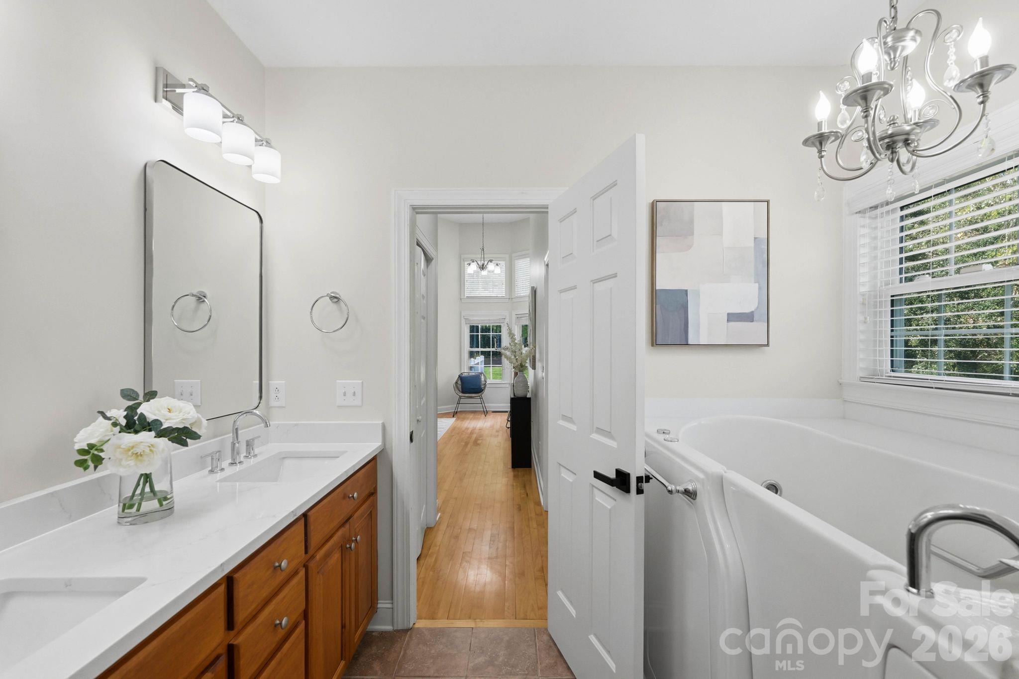 Sparkling white quartz vanity top and chrome fixtures - 803 Amanda Way, Albemarle