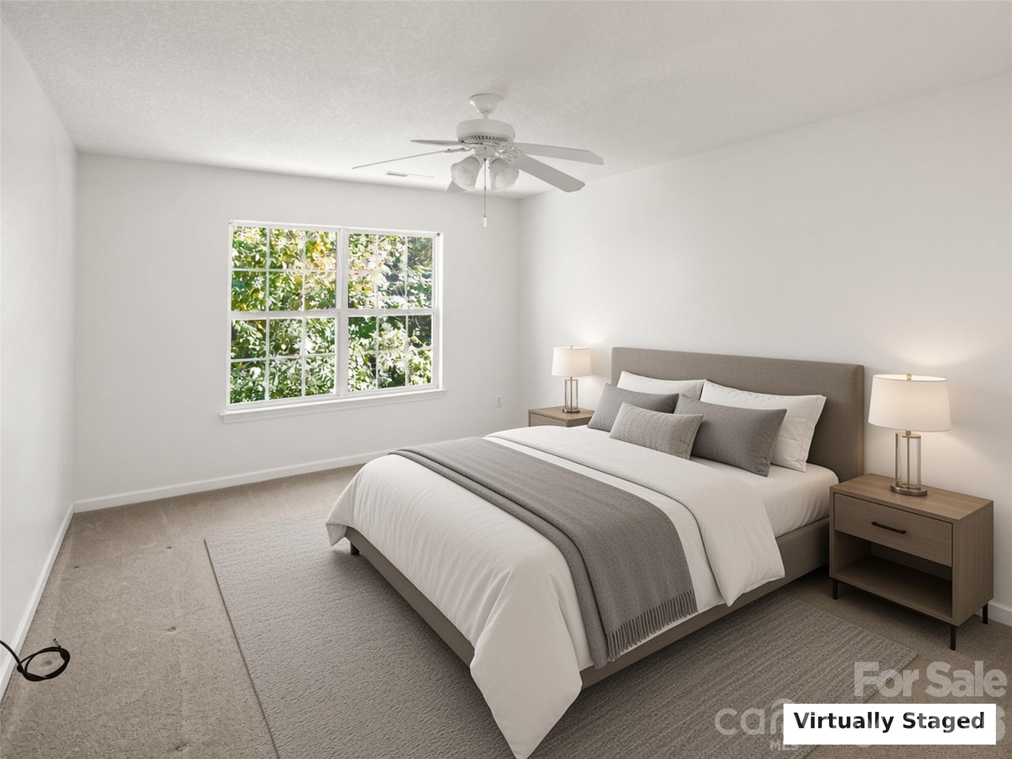 Virtually Staged. Bedroom with ceiling fan and wooded views. - 206 Waters Edge Drive, Weaverville