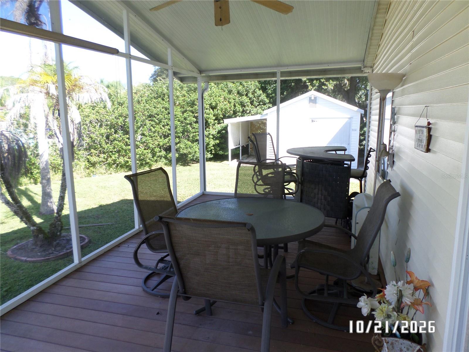 Screened in back porch with table & chairs and bar - 68 PALAMINO PATH, RIVER RANCH