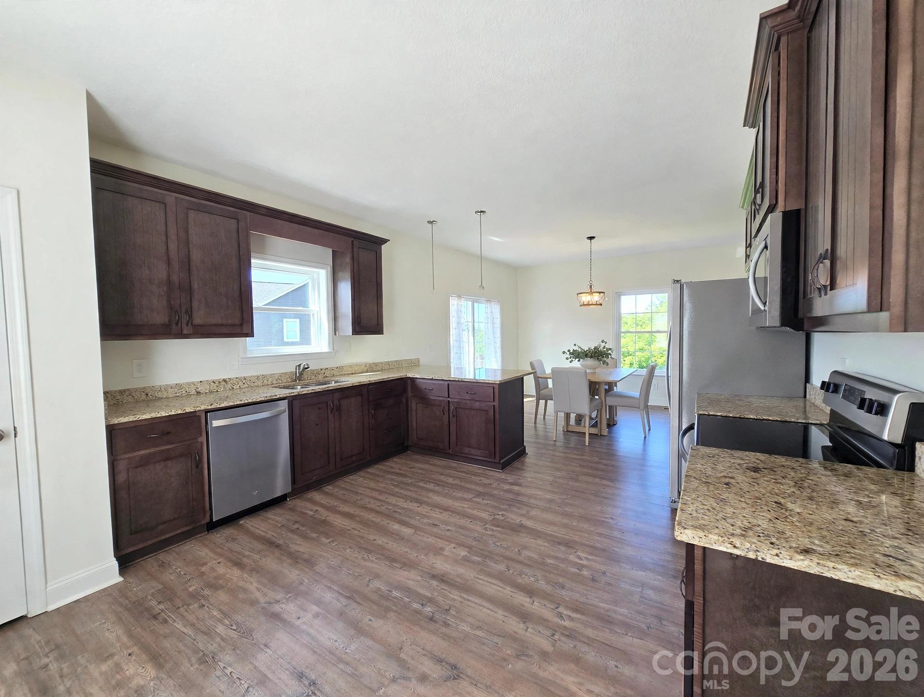 Kitchen with virtually staged dining in background - 37 Justice Drive, Leicester