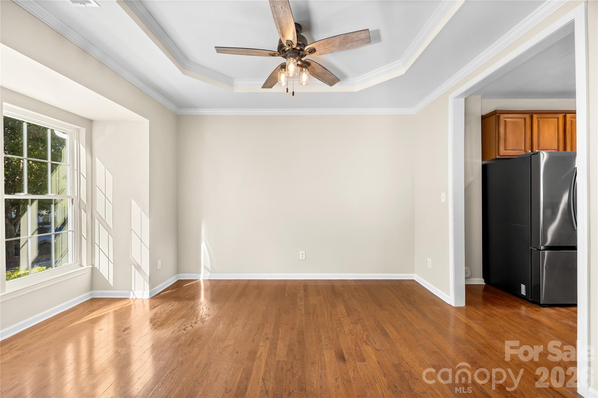 The dining room has a bay window and a tray ceiling. - 156 N Arcadian Way, Mooresville