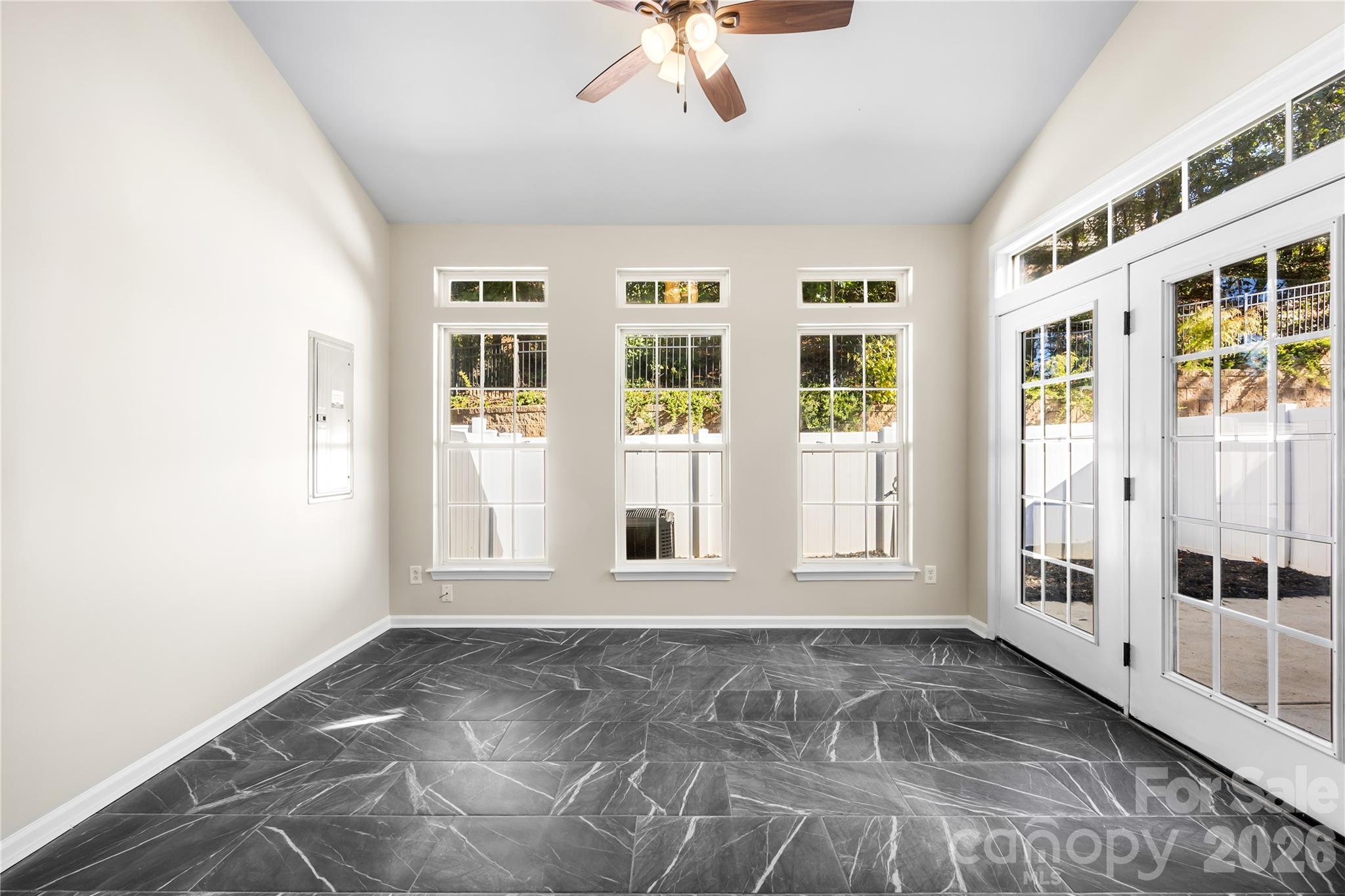 The sunroom features a wall of windows and a tile floor - 156 N Arcadian Way, Mooresville