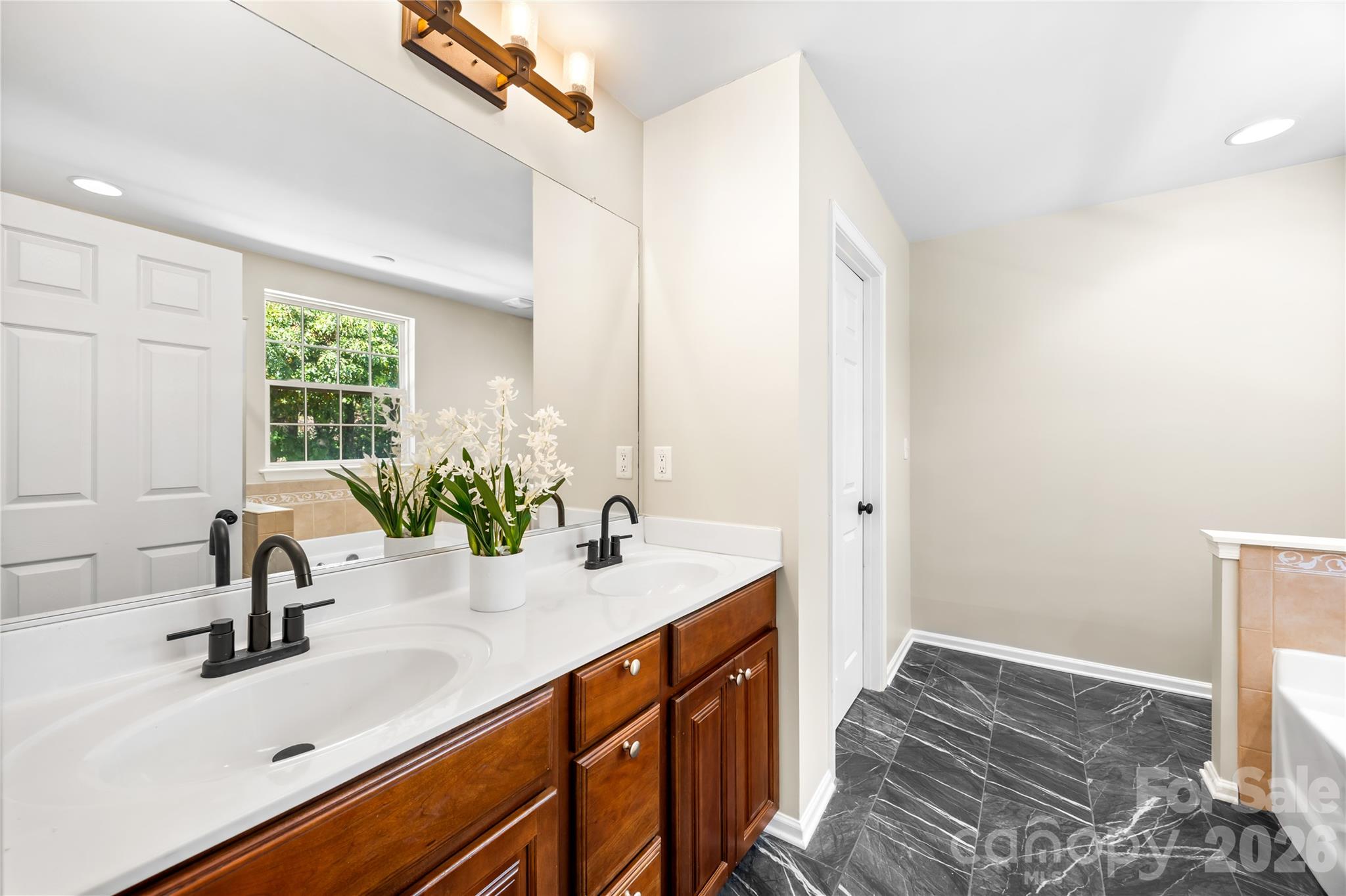 Primary bath with updated fixtures and tile floor - 156 N Arcadian Way, Mooresville