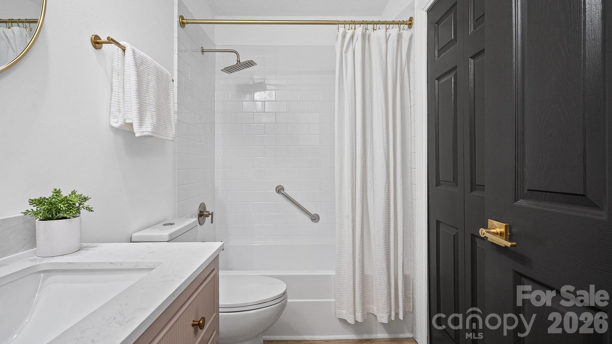 Remodeled Second Full Bathroom with New Vanity, New Countertop, New Dual Flush Commode, and Mixed Metal Accents - 8001 Saddlehorse Lane, Charlotte