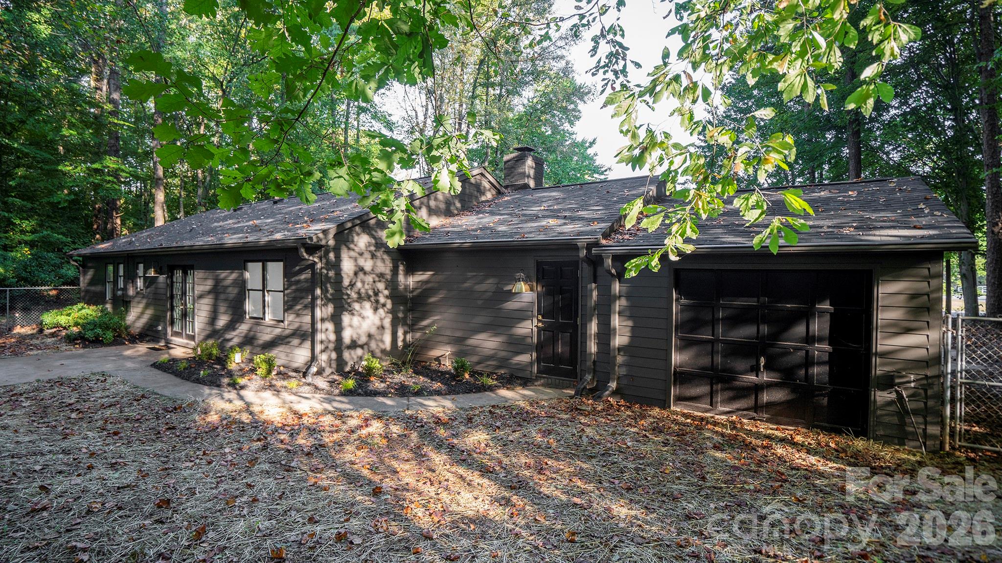 Freshly Seeded Backyard Lawn, Professional Landscaping, and New Black Mulch - 8001 Saddlehorse Lane, Charlotte
