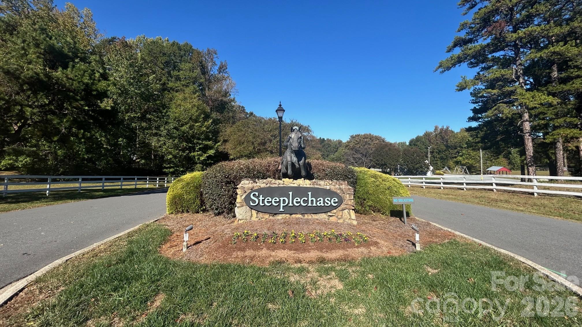 Steeplechase Neighborhood Showcases White Picket Fence Entrance with Beautiful Statue - 8001 Saddlehorse Lane, Charlotte