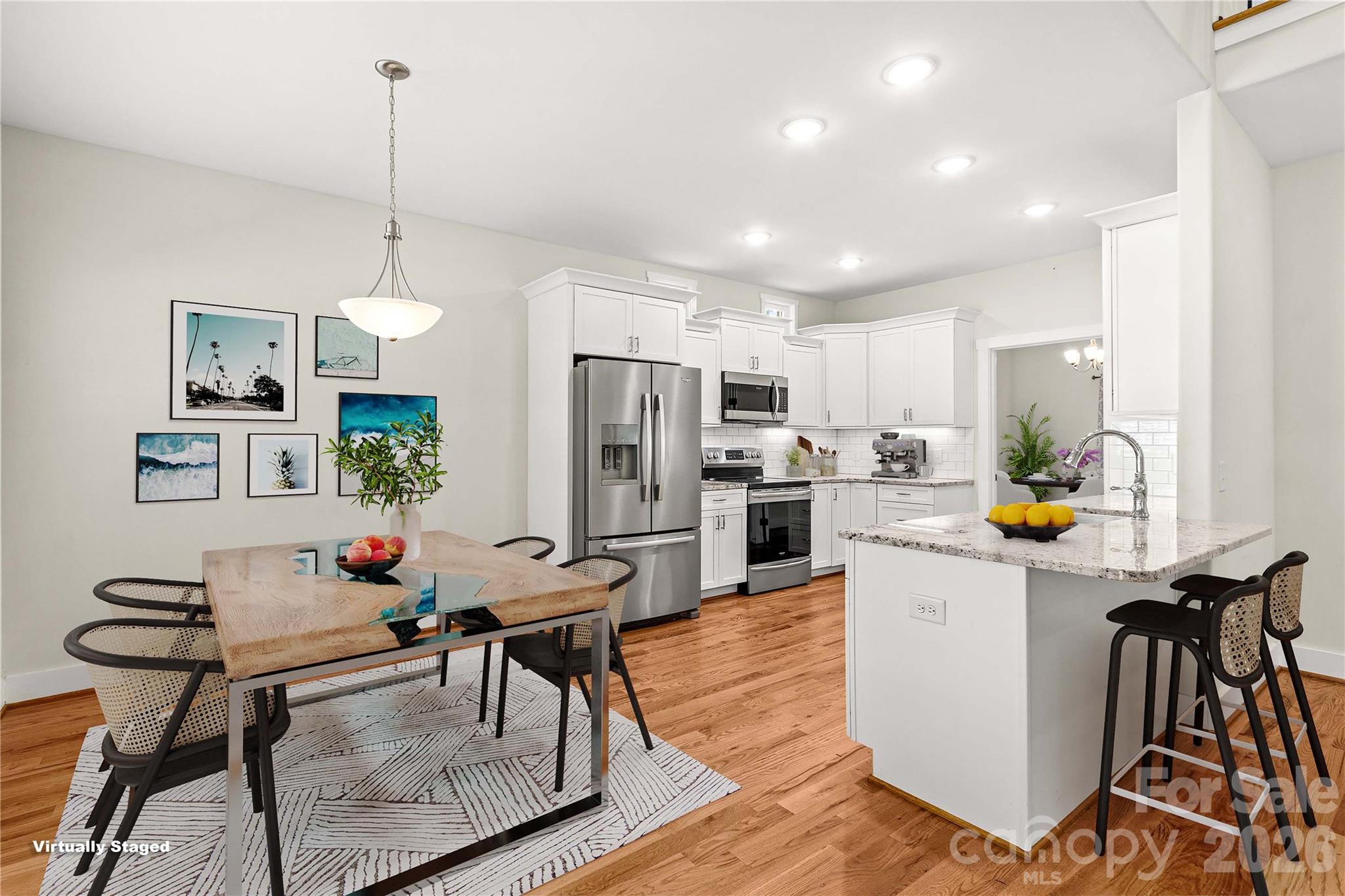 Breakfast area and kitchen virtually staged. So many furniture styles would work in this home. - 178 Nellwood Court, Mocksville