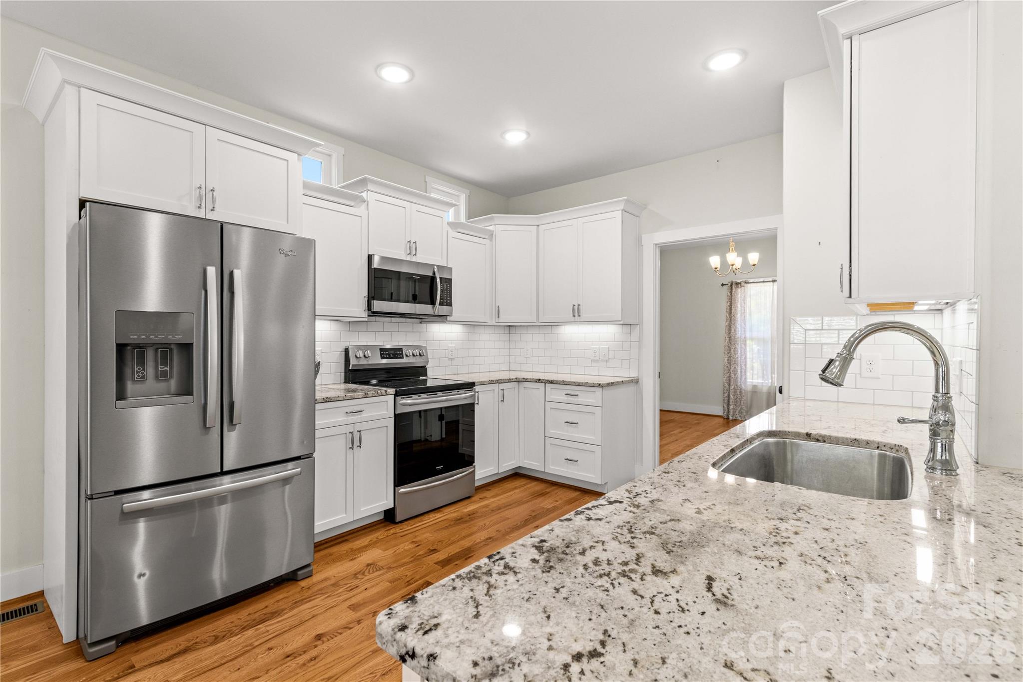 Modern kitchen with granite countertops, and SS appliances. Pantry closet not visible - 178 Nellwood Court, Mocksville