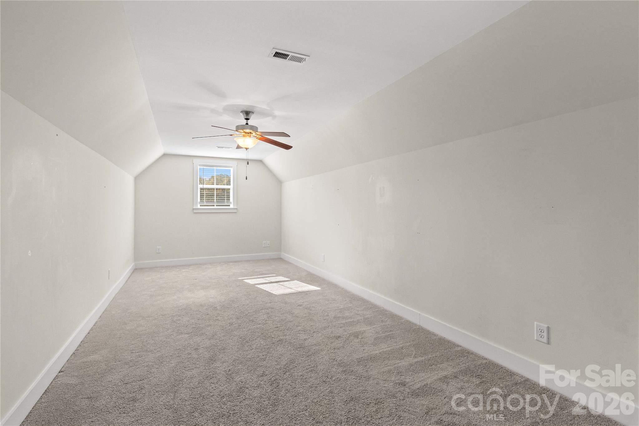 Bonus room with ceiling fan. - 178 Nellwood Court, Mocksville