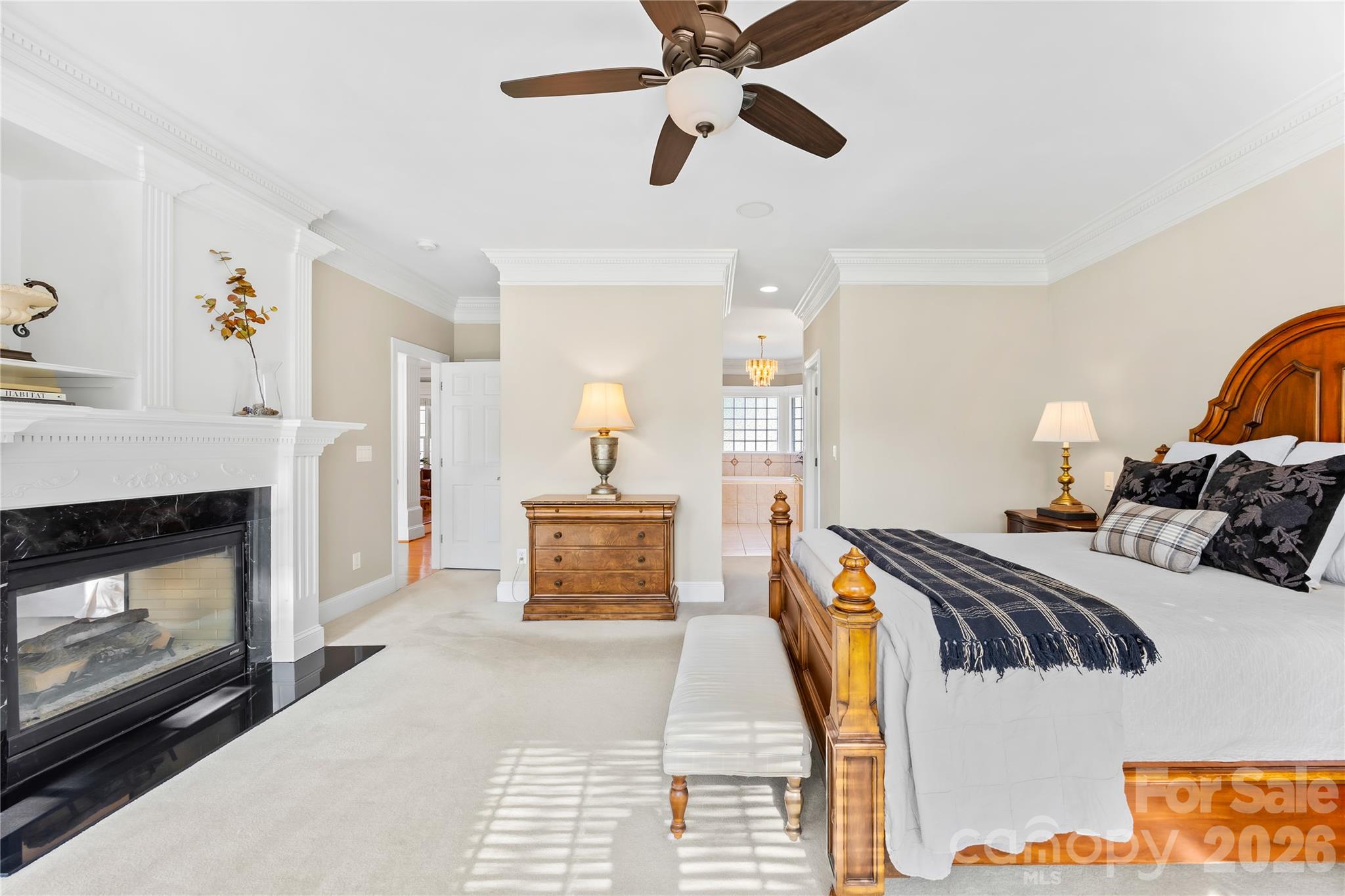 Primary Bedroom with a double-sided fireplace - 1410 Pine Needle Lane, Mooresville