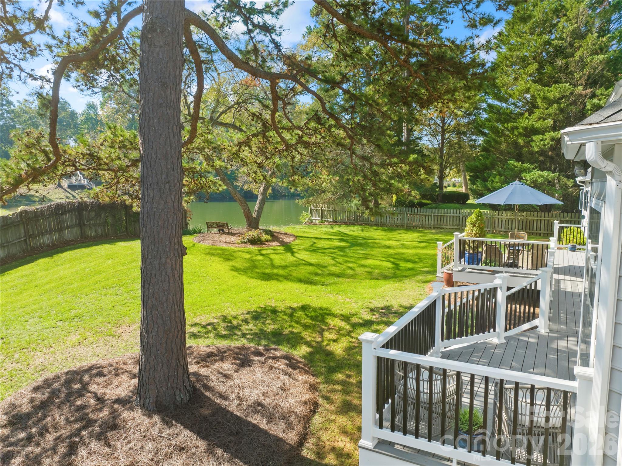 View from the back deck over the yard and to the pond - 1410 Pine Needle Lane, Mooresville