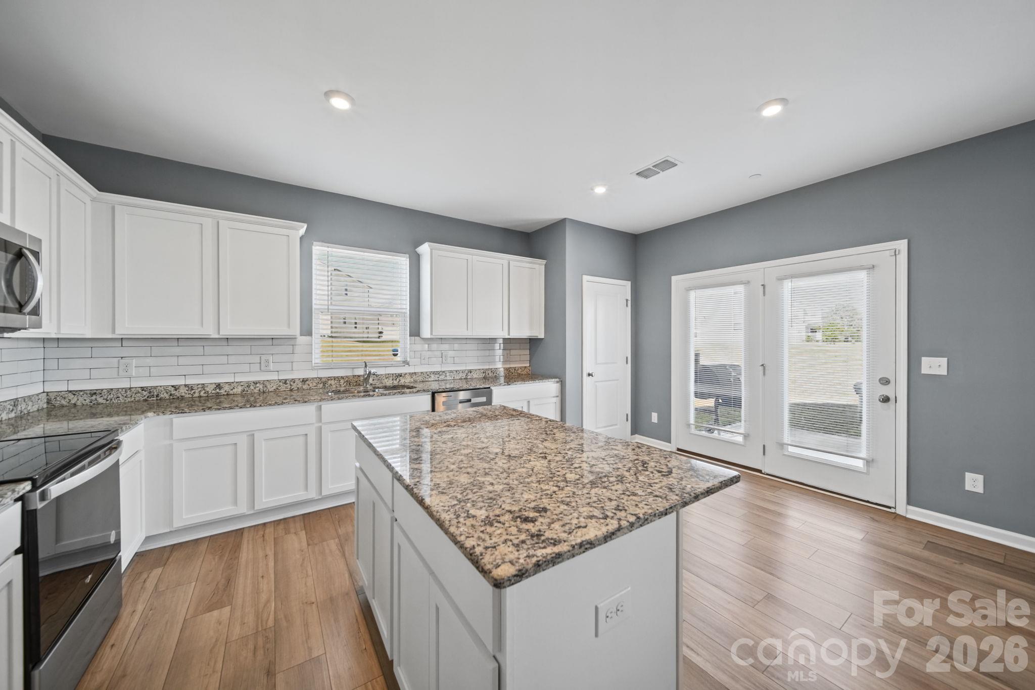 Kitchen, with Granite Countertops and Island. - 3082 Bell Spur Avenue SW, Concord