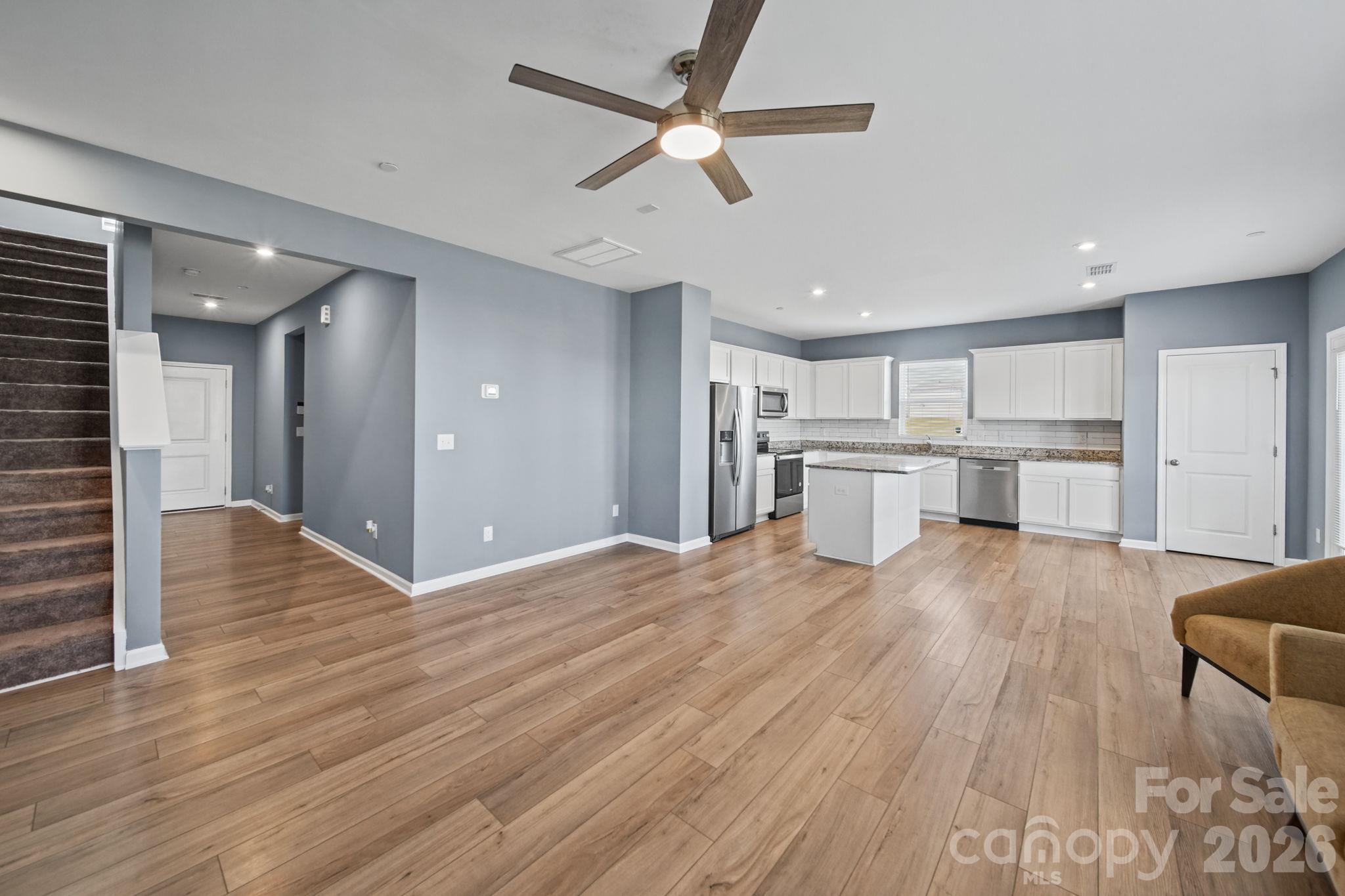 Open Floor Plan with New Ceiling Fan, and gorgeous Luxury Vinyl Plank Floors. - 3082 Bell Spur Avenue SW, Concord