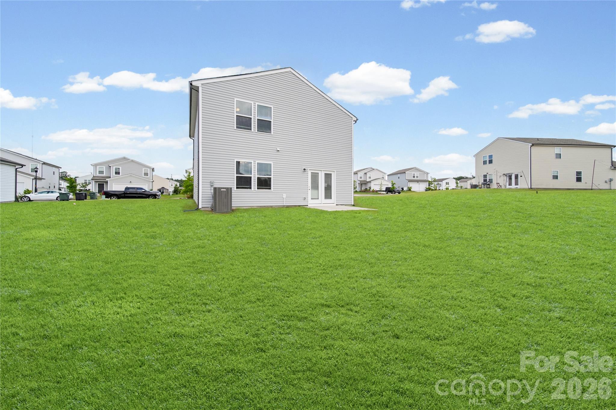 Back exterior of the home, focusing on the Home's clean look and large backyard. - 3082 Bell Spur Avenue SW, Concord