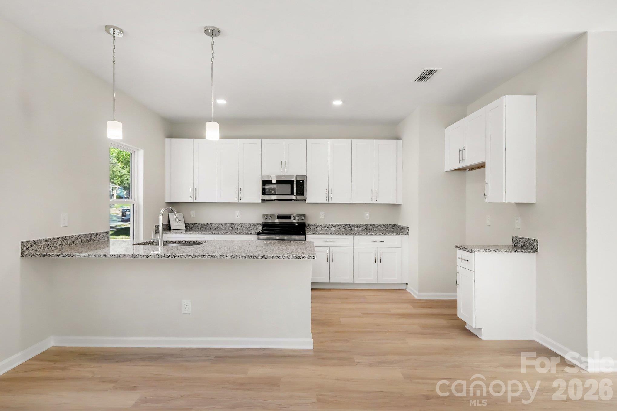 Kitchen and dining area of 125 Buffalo Ave NW actual photo non-staged - 125 Buffalo Avenue NW, Concord
