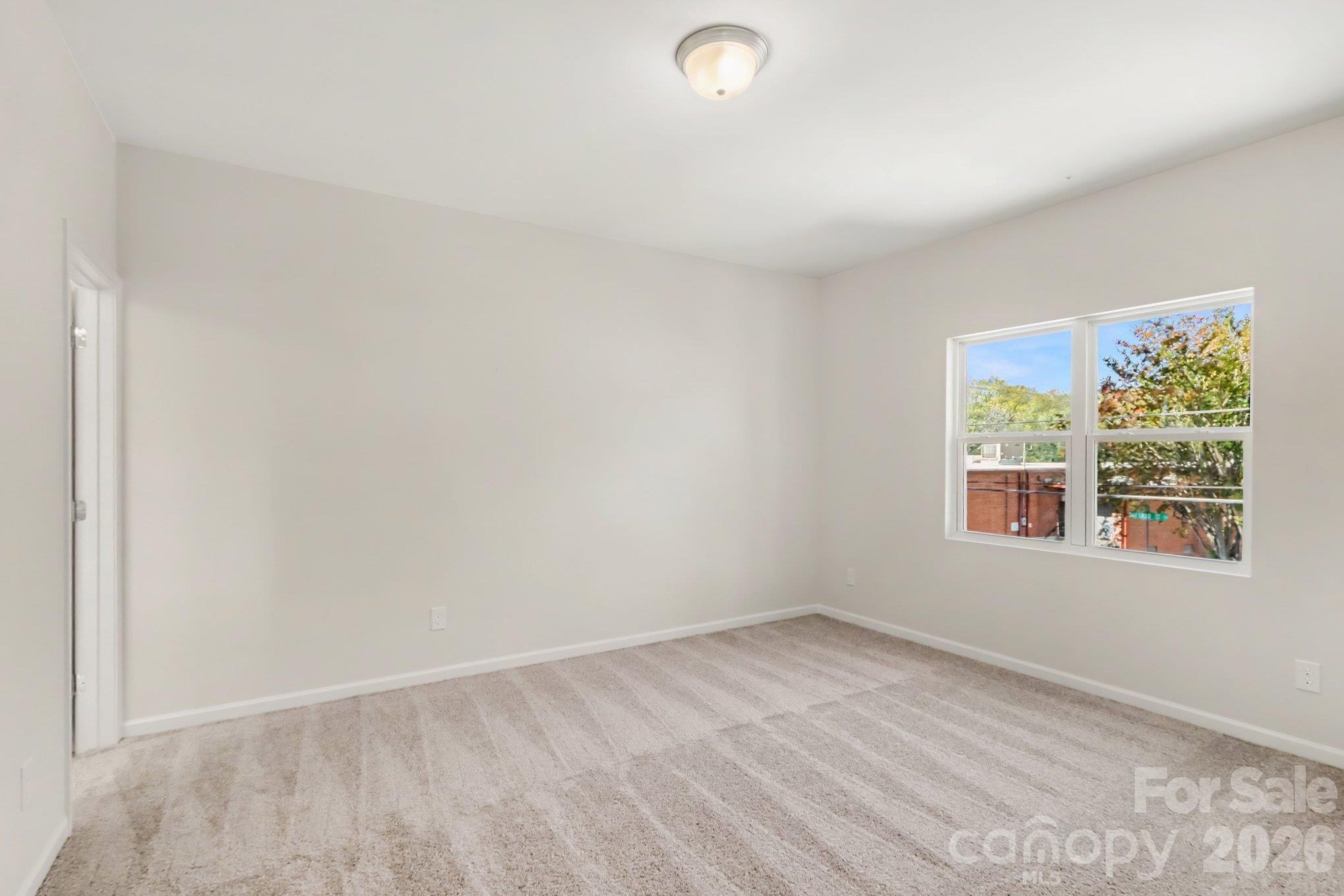 Primary bedroom on upper level with carpet flooring. Actual non-staged photo. - 125 Buffalo Avenue NW, Concord